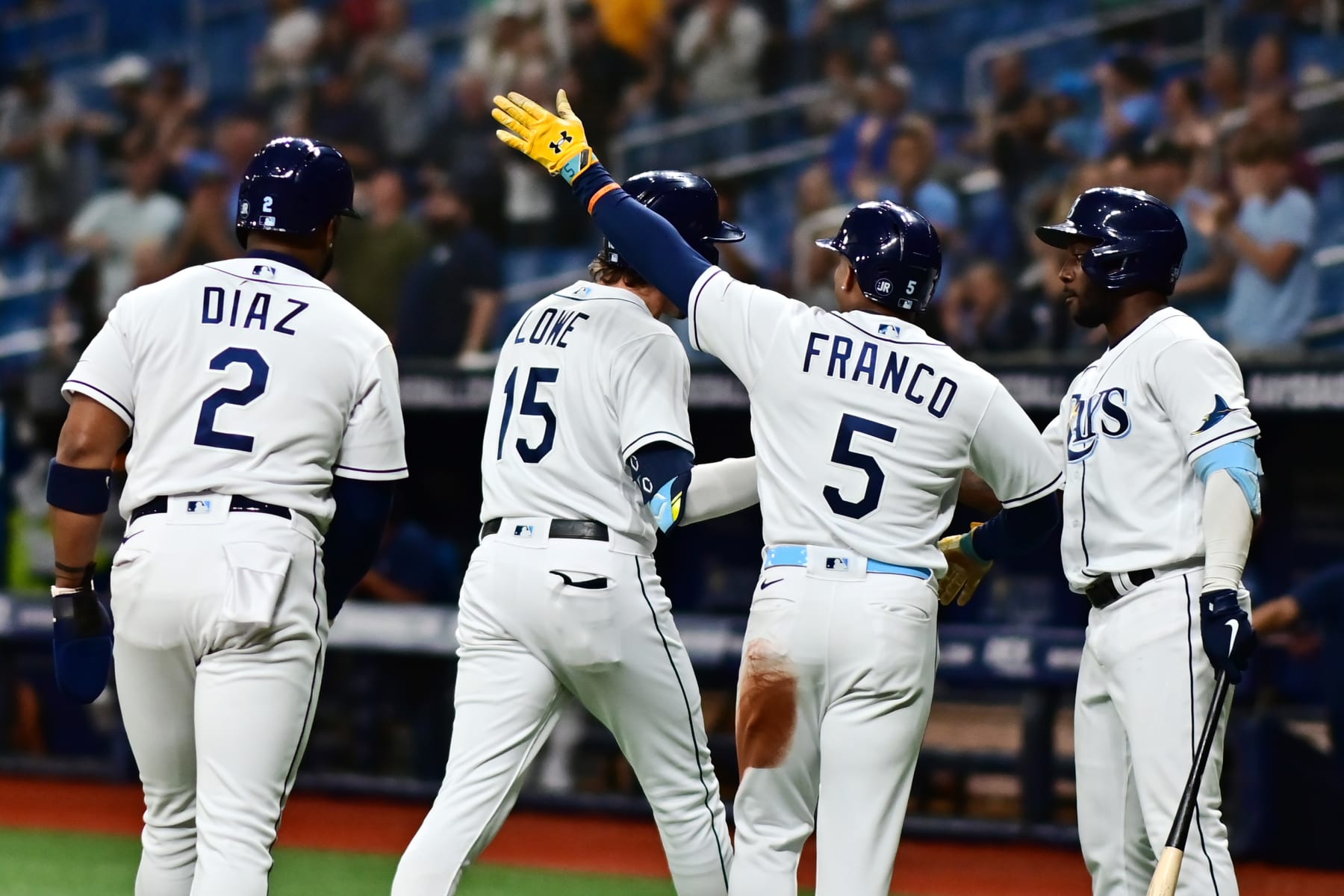 ST PETERSBURG, FLORIDA - APRIL 29: Josh Lowe #15 of the Tampa Bay Rays is congratulated by Randy Arozarena #56, Wander Franco #5, and Yandy Diaz #2 after hitting a three run home run in the first inning against the Minnesota Twins at Tropicana Field on April 29, 2022 in St Petersburg, Florida. (Photo by Julio Aguilar/Getty Images)