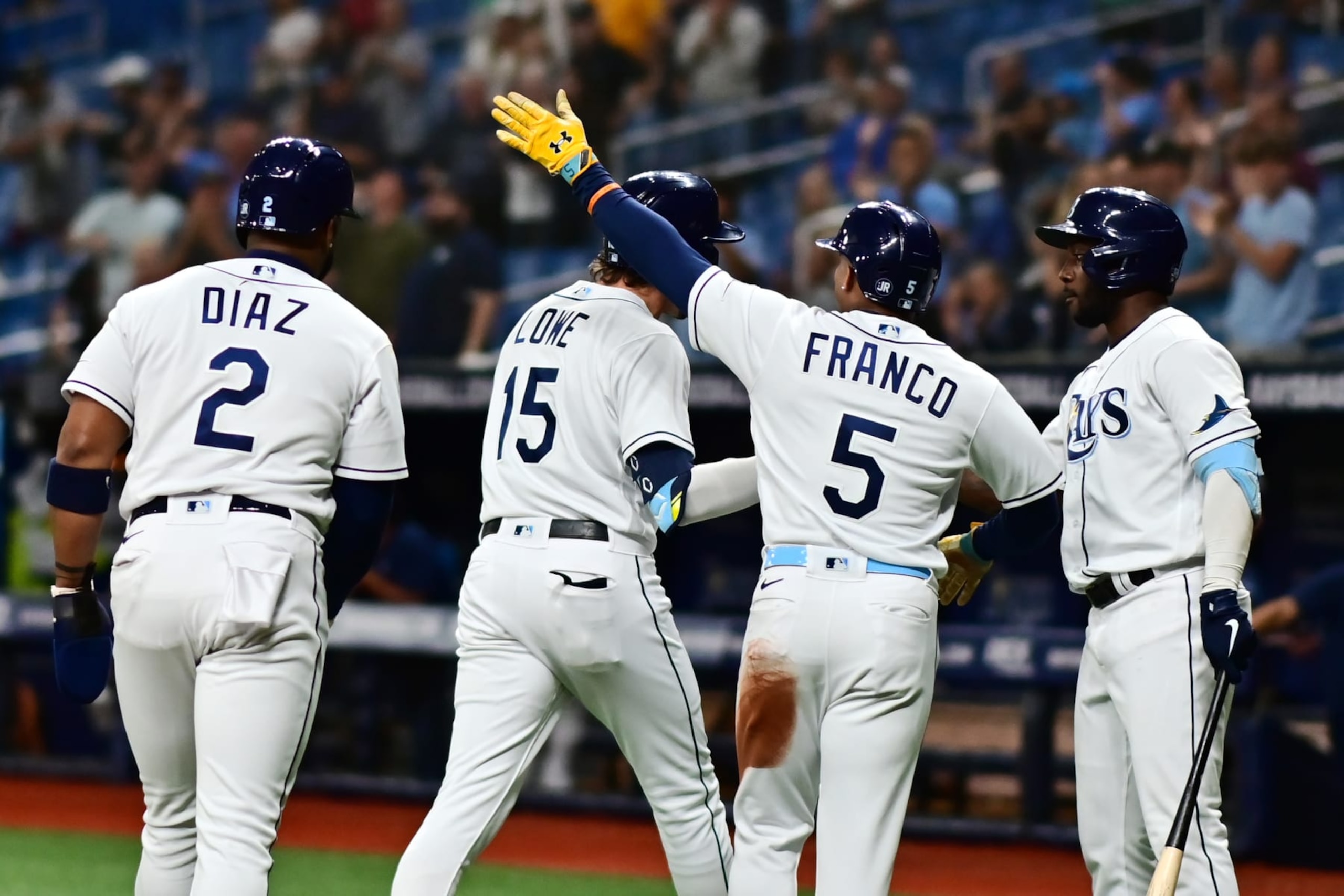 ST PETERSBURG, FLORIDA - APRIL 29: Josh Lowe #15 of the Tampa Bay Rays is congratulated by Randy Arozarena #56, Wander Franco #5, and Yandy Diaz #2 after hitting a three run home run in the first inning against the Minnesota Twins at Tropicana Field on April 29, 2022 in St Petersburg, Florida. (Photo by Julio Aguilar/Getty Images)