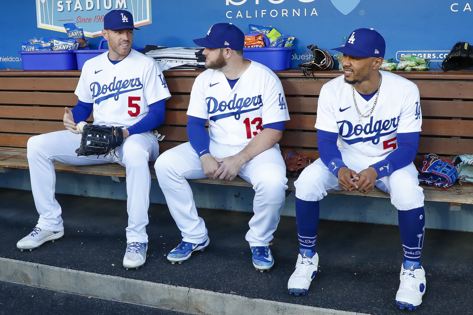 LOS ANGELES, CA - APRIL 29: Los Angeles Dodgers first baseman Freddie Freeman (5), third basemen Max Muncy (13), and right fielder Mookie Betts (50) sit on the bench prior to a regular season game between the St. Louis Cardinals and Los Angeles Dodgers on April 29, 2023 at Dodger Stadium in Los Angeles, CA. (Photo by Brandon Sloter/Icon Sportswire via Getty Images)