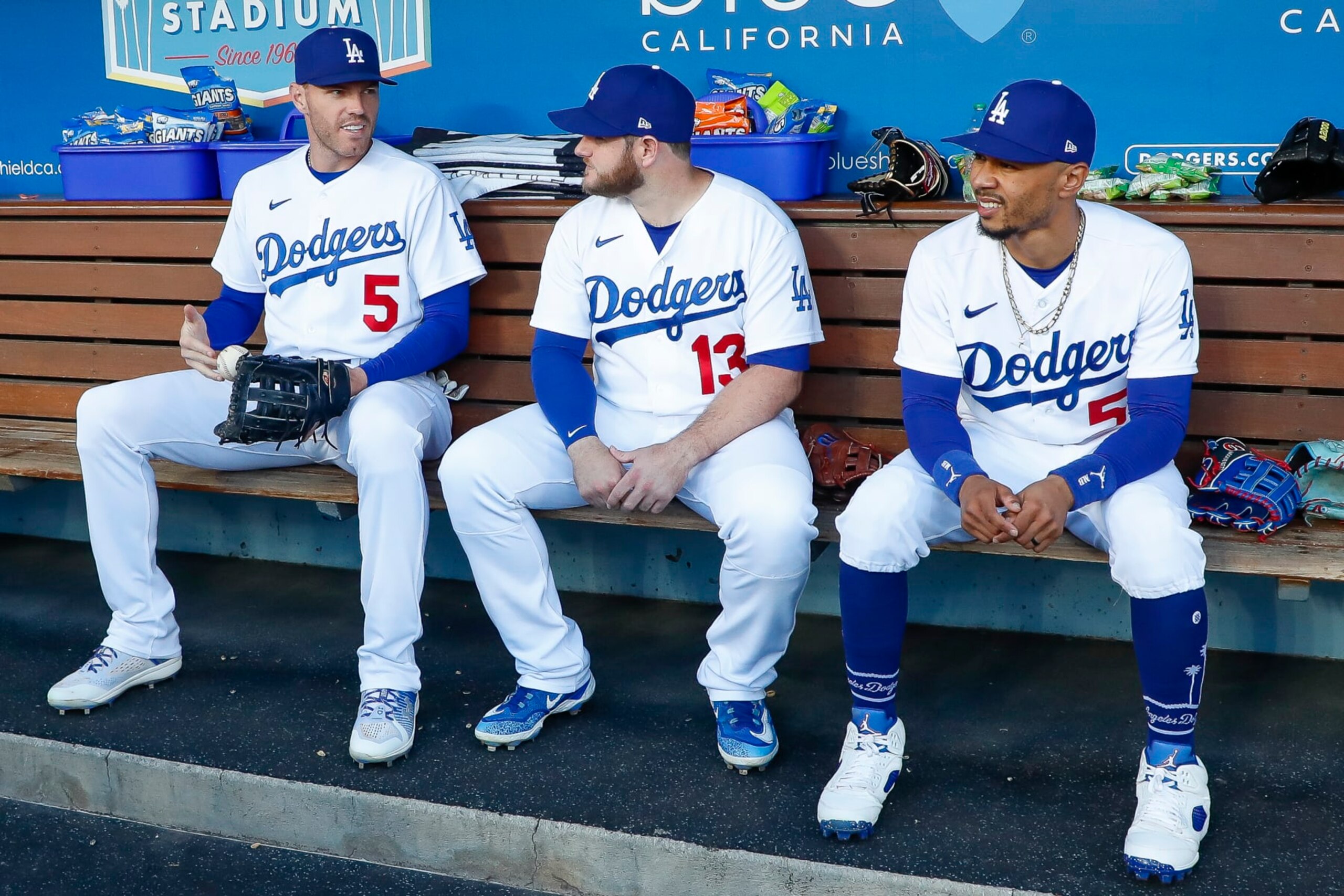 LOS ANGELES, CA - APRIL 29: Los Angeles Dodgers first baseman Freddie Freeman (5), third basemen Max Muncy (13), and right fielder Mookie Betts (50) sit on the bench prior to a regular season game between the St. Louis Cardinals and Los Angeles Dodgers on April 29, 2023 at Dodger Stadium in Los Angeles, CA. (Photo by Brandon Sloter/Icon Sportswire via Getty Images)