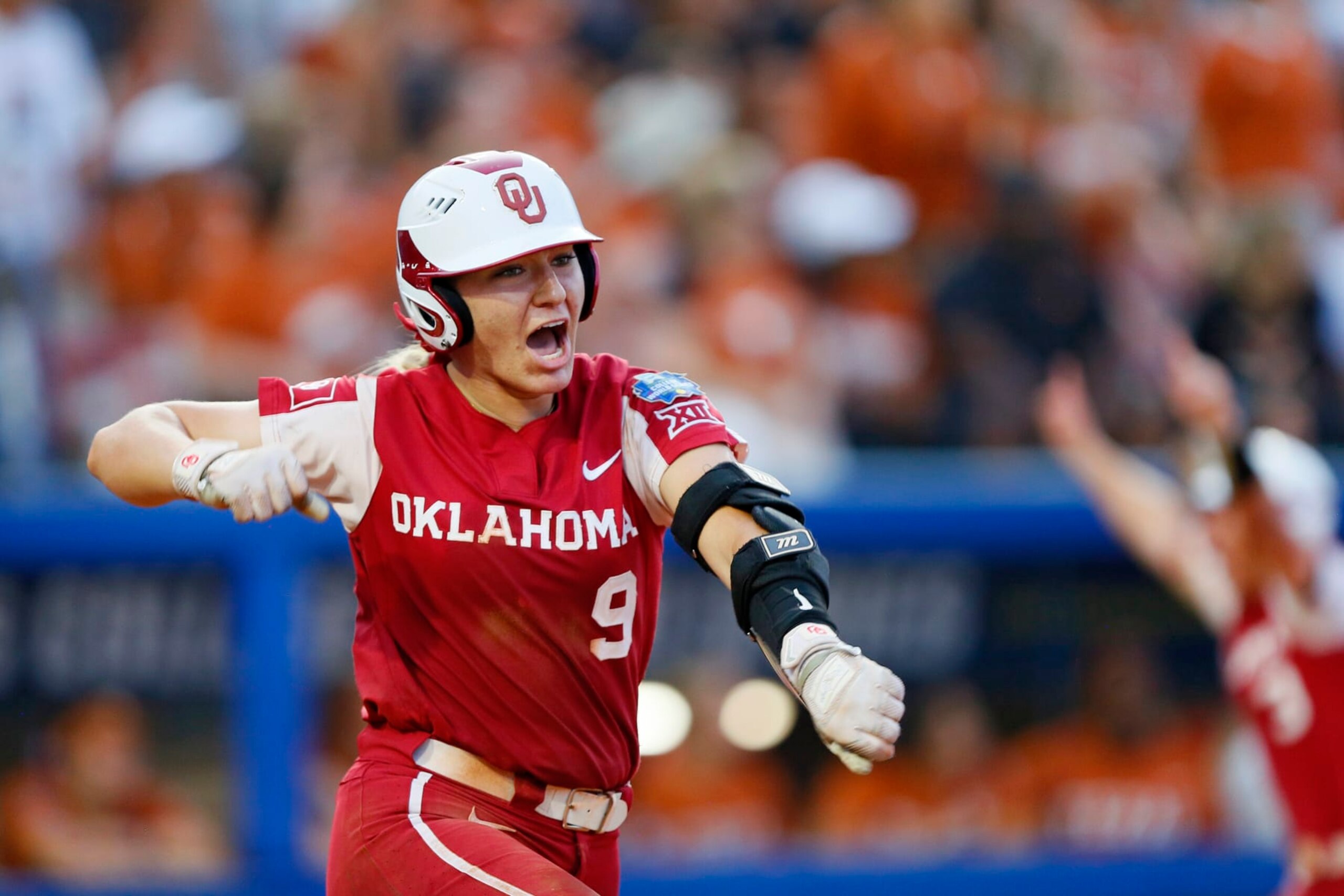 OKLAHOMA CITY, OK - JUNE 9:  Kinzie Hansen #9 of the Oklahoma Sooners pumps her fist after hitting a three-run home run to secure the lead at 6-2 against the Texas Longhorns in the fifth inning during the NCAA Women's College World Series finals at the USA Softball Hall of Fame Complex on June 9, 2022 in Oklahoma City, Oklahoma.  Oklahoma won the NCAA Championship with a 10-5 victory.  (Photo by Brian Bahr/Getty Images)