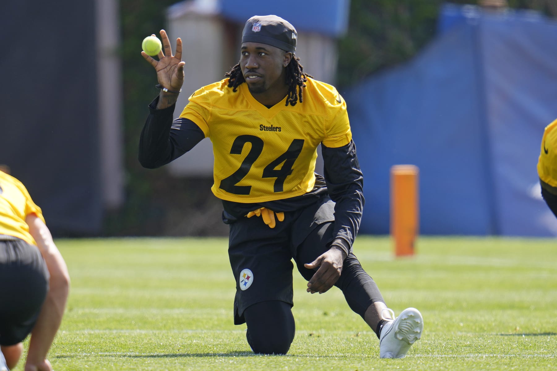 Pittsburgh Steelers cornerback Joey Porter Jr., a second round draft pick, catches a ball tossed to him by a coach while stretching during the NFL football team's rookie minicamp in Pittsburgh, Friday, May 12, 2023. (AP Photo/Gene J. Puskar)