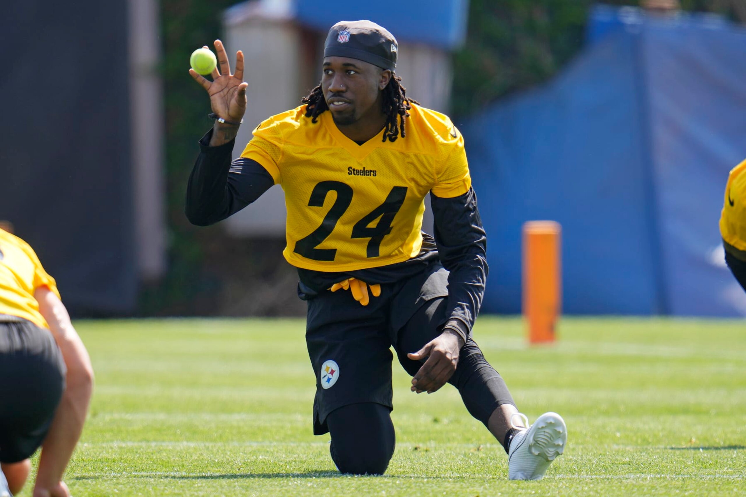 Pittsburgh Steelers cornerback Joey Porter Jr., a second round draft pick, catches a ball tossed to him by a coach while stretching during the NFL football team's rookie minicamp in Pittsburgh, Friday, May 12, 2023. (AP Photo/Gene J. Puskar)