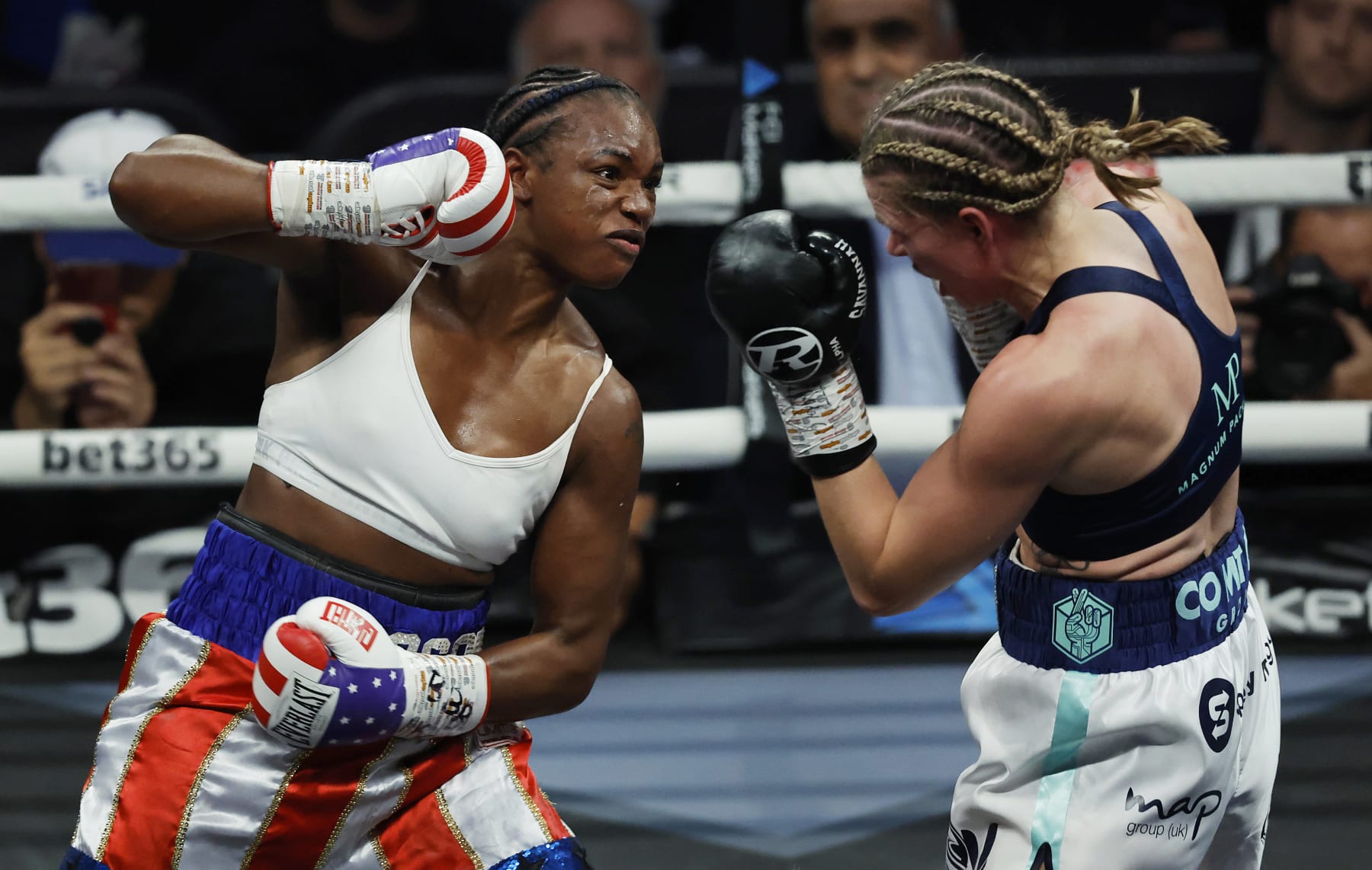 Claressa Shields (L) punches Savannah Marshall (R) during the IBF, WBA, WBC, WBO World Middleweight Title fight during the historic all-women boxing card at the O2 Arena on October 15th 2022 in London (Photo by Tom Jenkins/Getty Images)