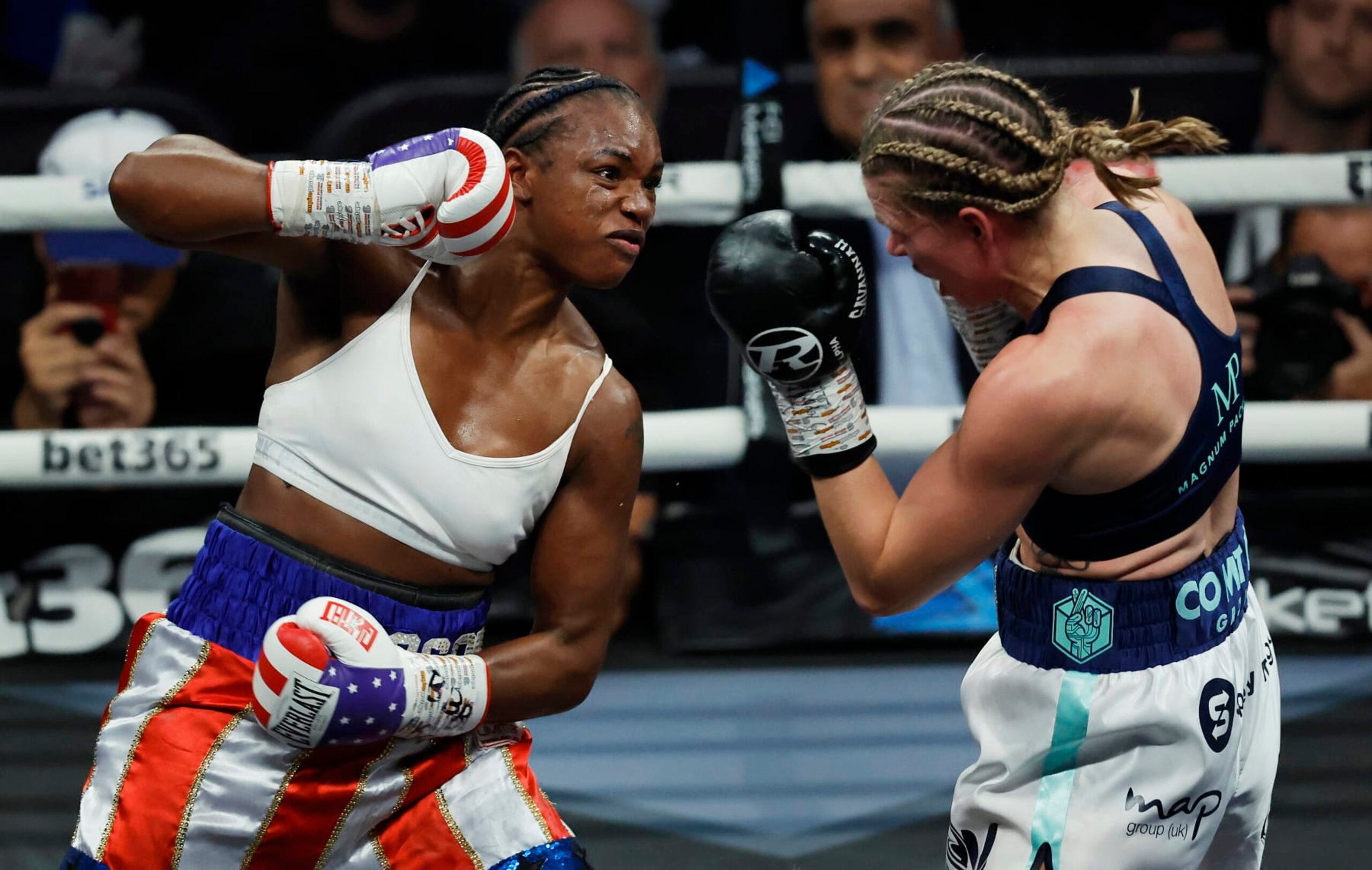 Claressa Shields (L) punches Savannah Marshall (R) during the IBF, WBA, WBC, WBO World Middleweight Title fight during the historic all-women boxing card at the O2 Arena on October 15th 2022 in London (Photo by Tom Jenkins/Getty Images)