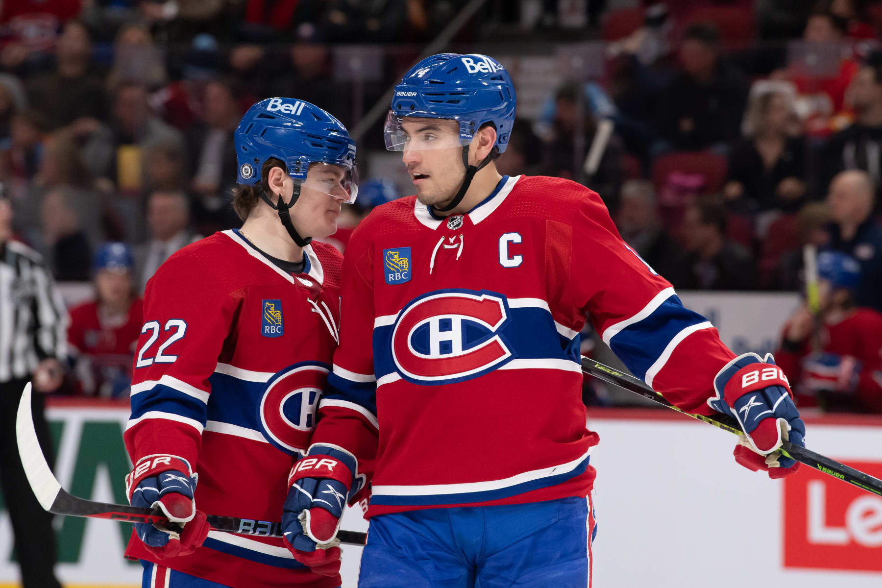 MONTREAL, CANADA - DECEMBER 12: Cole Caufield #22 and Nick Suzuki #14 of the Montreal Canadiens exchange words during the second period in the NHL game against the Calgary Flames at the Centre Bell on December 12, 2022 in Montreal, Quebec, Canada. (Photo by Francois Lacasse/NHLI via Getty Images)