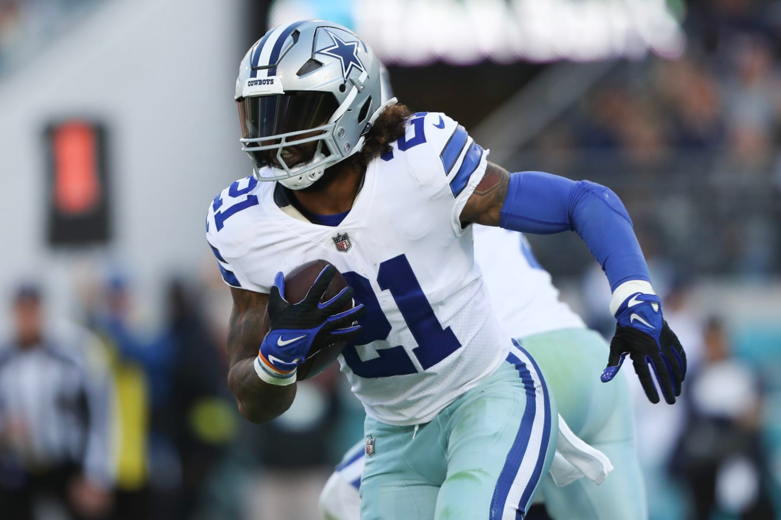 JACKSONVILLE, FLORIDA - DECEMBER 18: Ezekiel Elliott #21 of the Dallas Cowboys carries the ball during the second half against the Jacksonville Jaguars at TIAA Bank Field on December 18, 2022 in Jacksonville, Florida. (Photo by Courtney Culbreath/Getty Images)