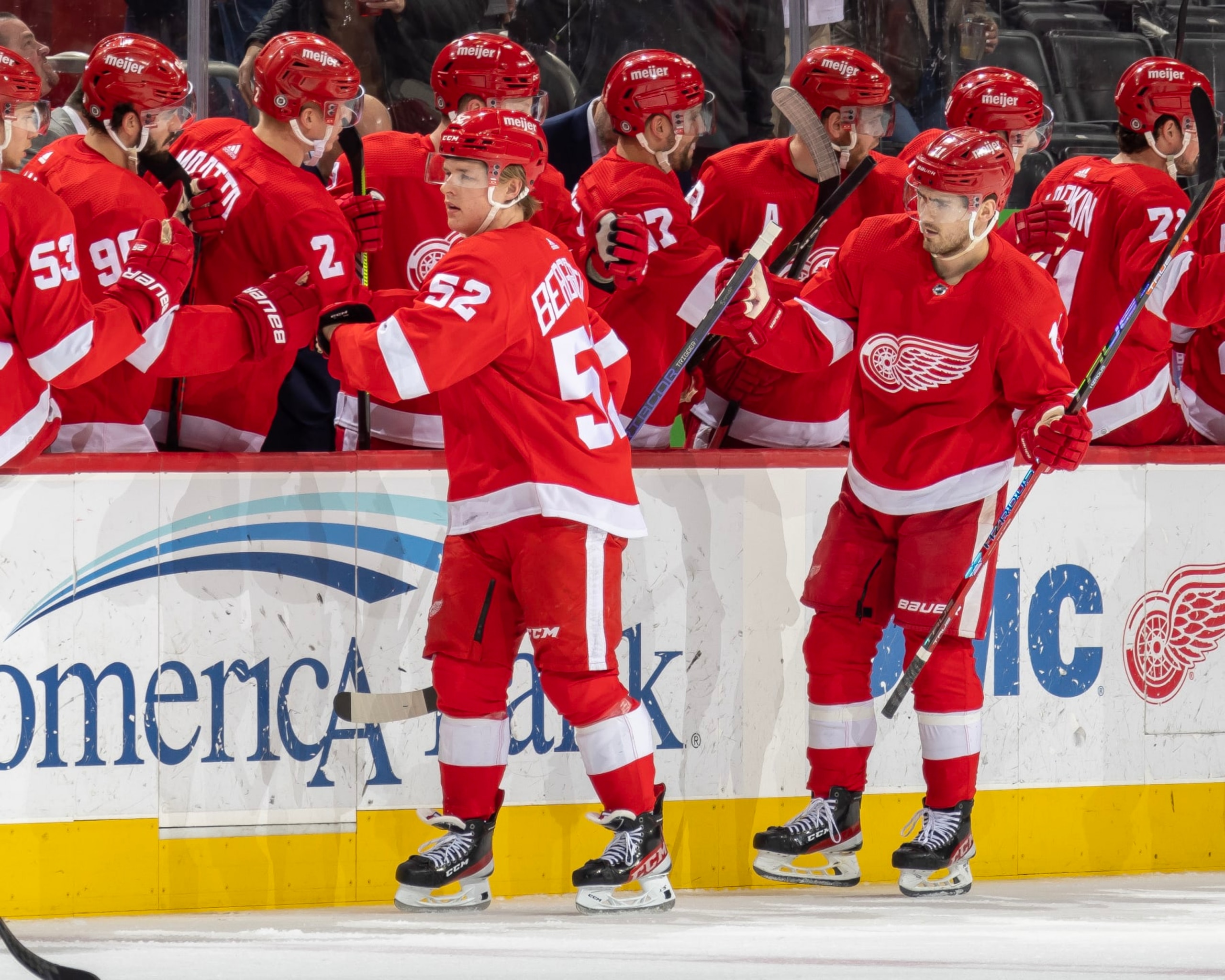 DETROIT, MI - MARCH 02: Jonatan Berggren #52 and Filip Zadina #11 of the Detroit Red Wings pounds gloves with with teammates on the bench during the second period of an NHL game against the Seattle Kraken at Little Caesars Arena on March 2, 2023 in Detroit, Michigan. (Photo by Dave Reginek/NHLI via Getty Images)