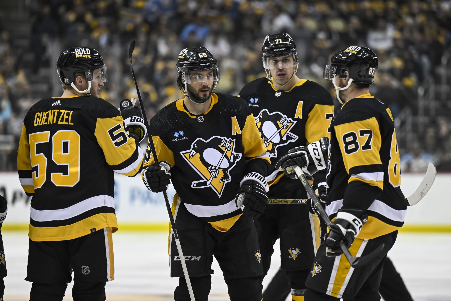 PITTSBURGH, PA - APRIL 11: Pittsburgh Penguins center Sidney Crosby (87), Pittsburgh Penguins Defenseman Kris Letang (58), Pittsburgh Penguins Center Evgeni Malkin (71), and Pittsburgh Penguins Left Wing Jake Guentzel (59) talk before a power play during the third period in the NHL game between the Pittsburgh Penguins and the Chicago Blackhawks on April 11, 2023, at PPG Paints Arena in Pittsburgh, PA. (Photo by Jeanine Leech/Icon Sportswire via Getty Images)