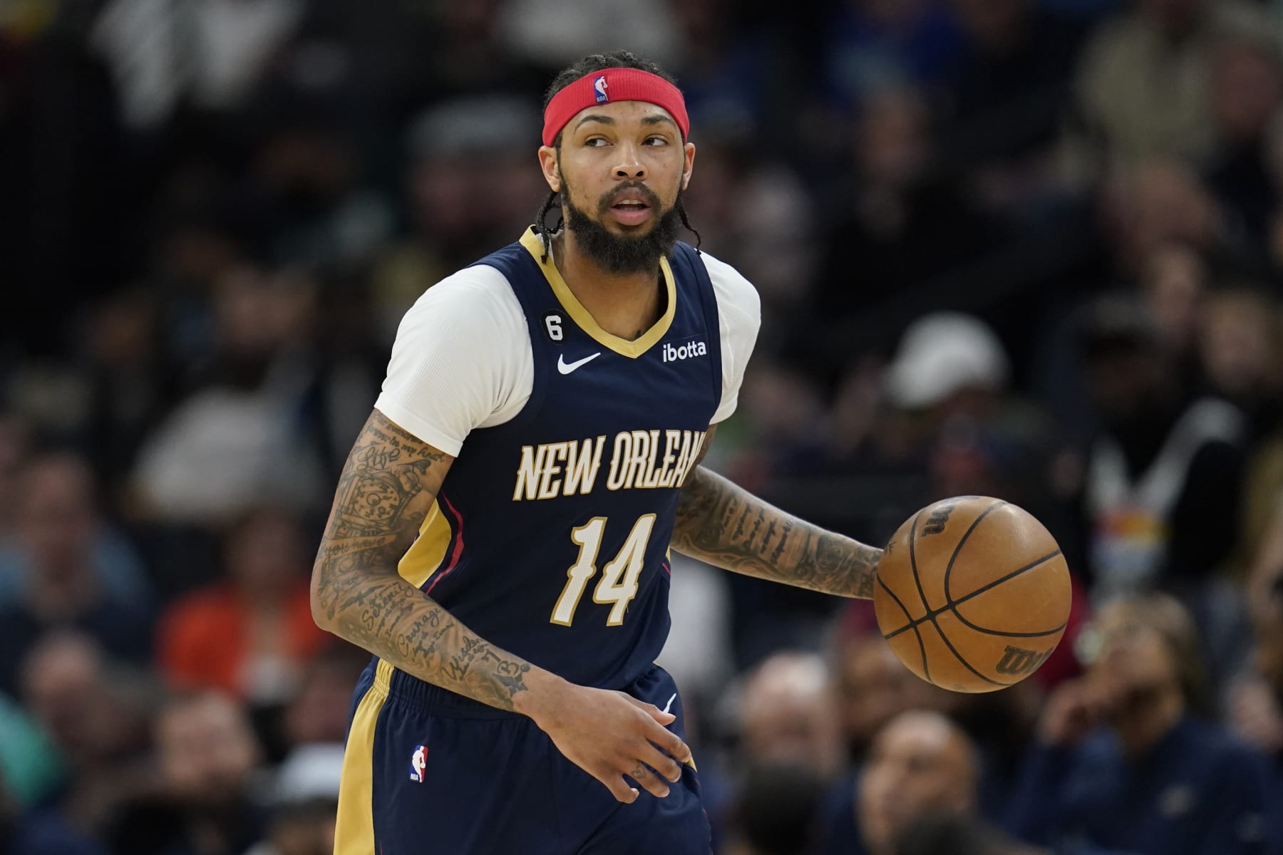 New Orleans Pelicans forward Brandon Ingram (14) dribbles toward the basket during the first half of an NBA basketball game against the Minnesota Timberwolves, Sunday, April 9, 2023, in Minneapolis. (AP Photo/Abbie Parr)