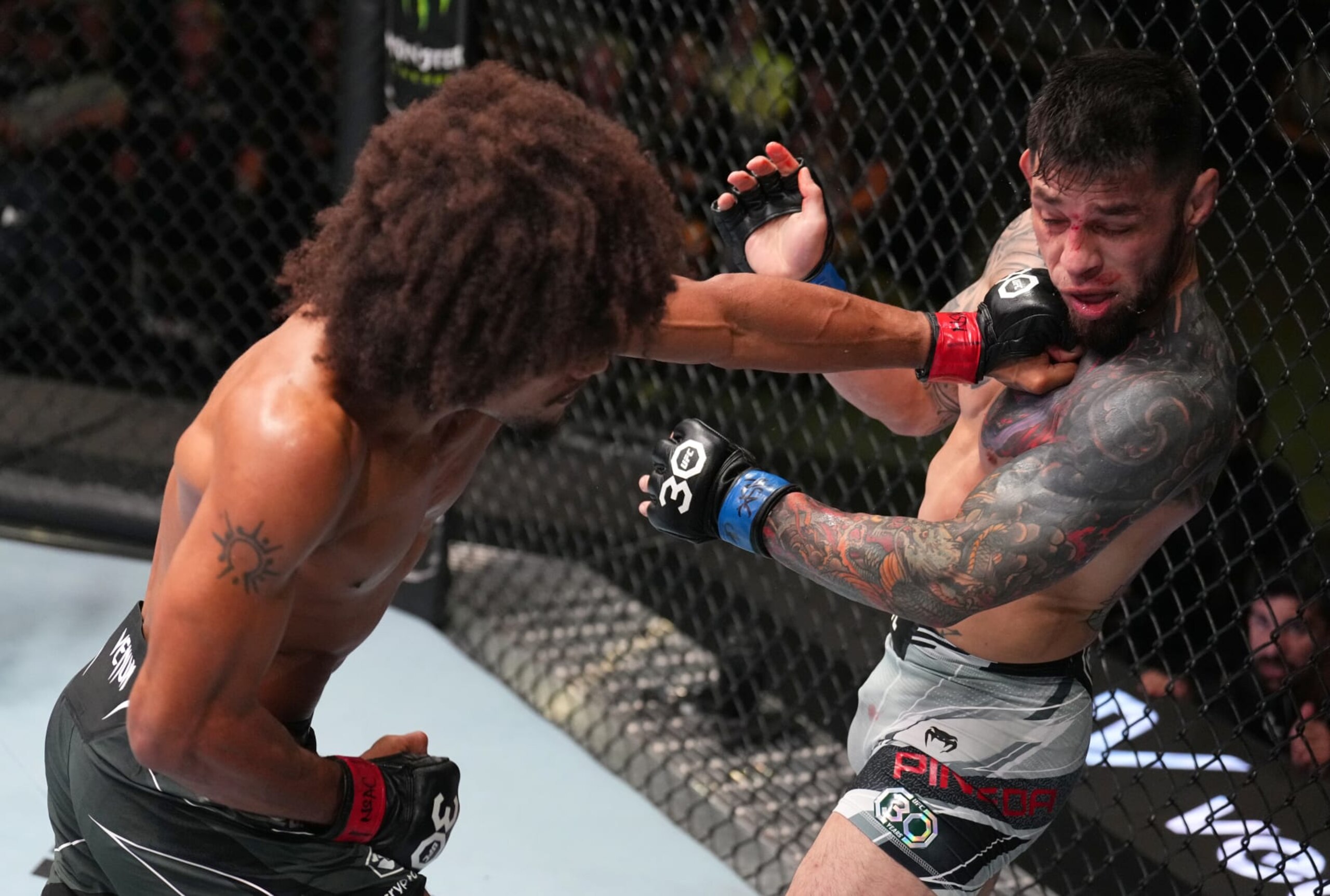 LAS VEGAS, NEVADA - JUNE 03: (L-R) Alex Caceres punches Daniel Pineda in a featherweight bout during the UFC Fight Night event at UFC APEX on June 03, 2023 in Las Vegas, Nevada. (Photo by Chris Unger/Zuffa LLC via Getty Images)