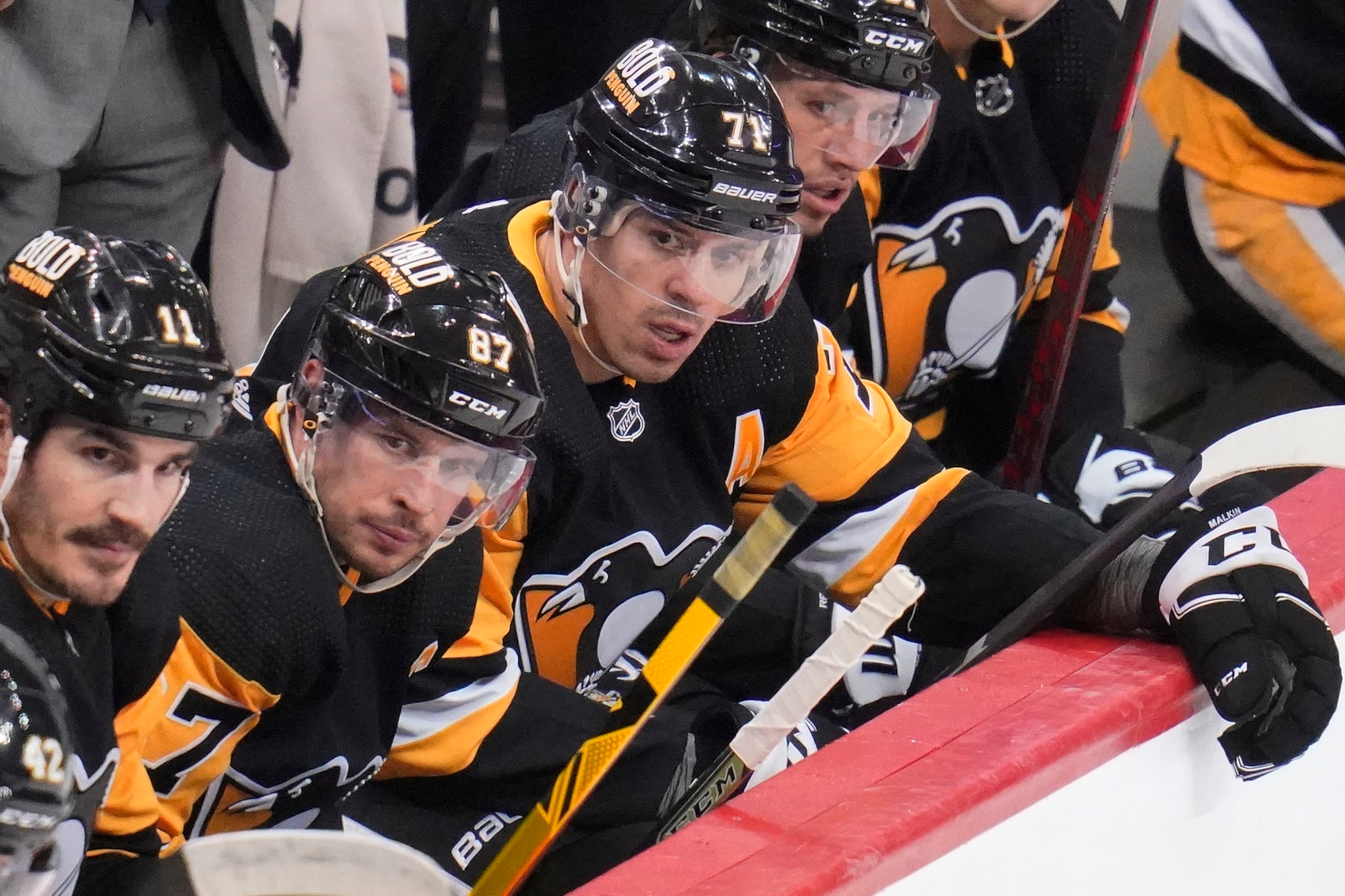 Pittsburgh Penguins' Sidney Crosby (87) and Evgeni Malkin (71) sit on the bench during the third period of an NHL hockey game against the Columbus Blue Jackets in Pittsburgh, Friday, April 29, 2022. The Penguins won the final regular season game 5-3.(AP Photo/Gene J. Puskar)