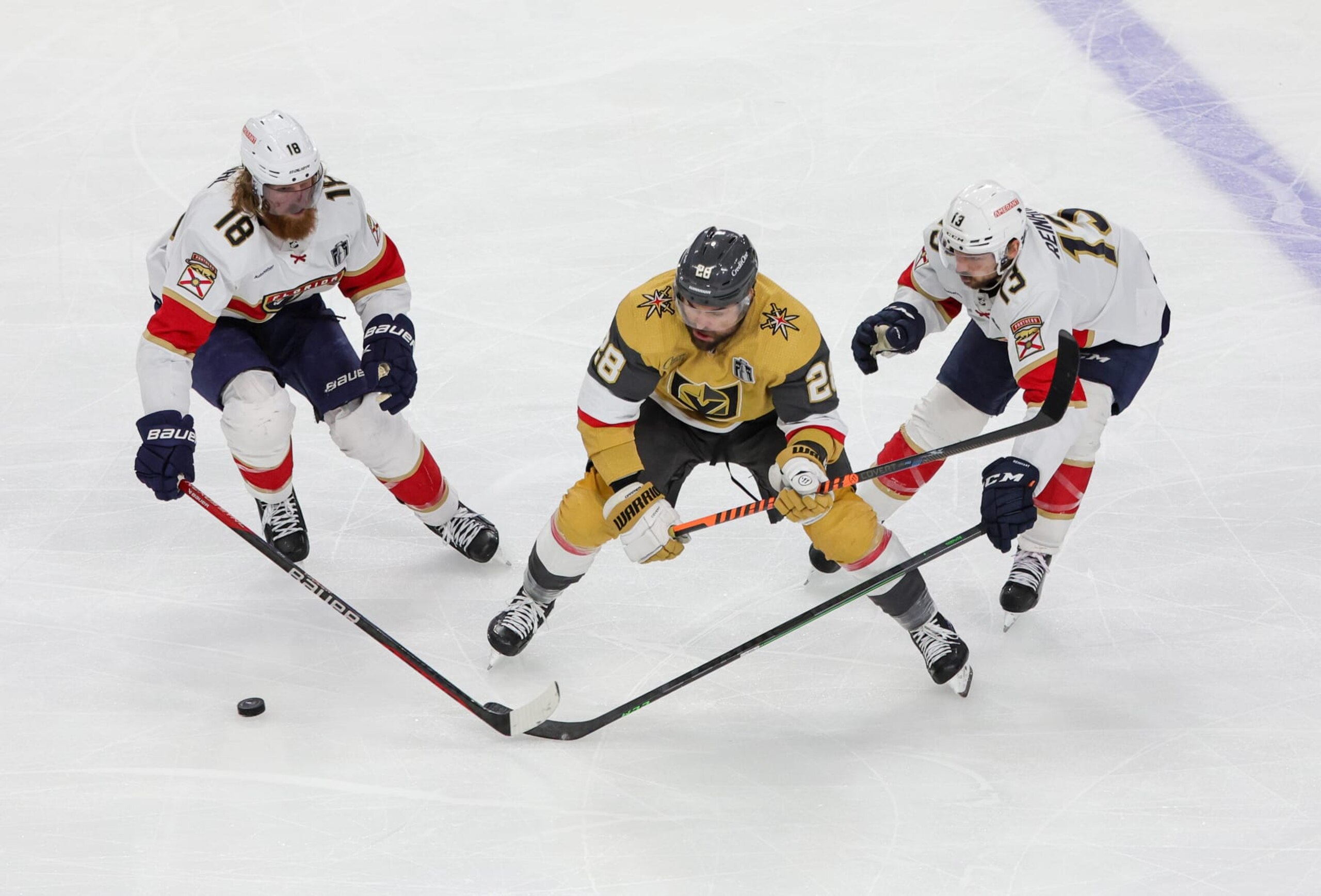 LAS VEGAS, NEVADA - JUNE 03: Marc Staal #18 and Sam Reinhart #13 of the Florida Panthers and William Carrier #28 of the Vegas Golden Knights vie for the puck in the third period of Game One of the 2023 NHL Stanley Cup Final at T-Mobile Arena on June 03, 2023 in Las Vegas, Nevada. The Golden Knights defeated the Panthers 5-2. (Photo by Ethan Miller/Getty Images)
