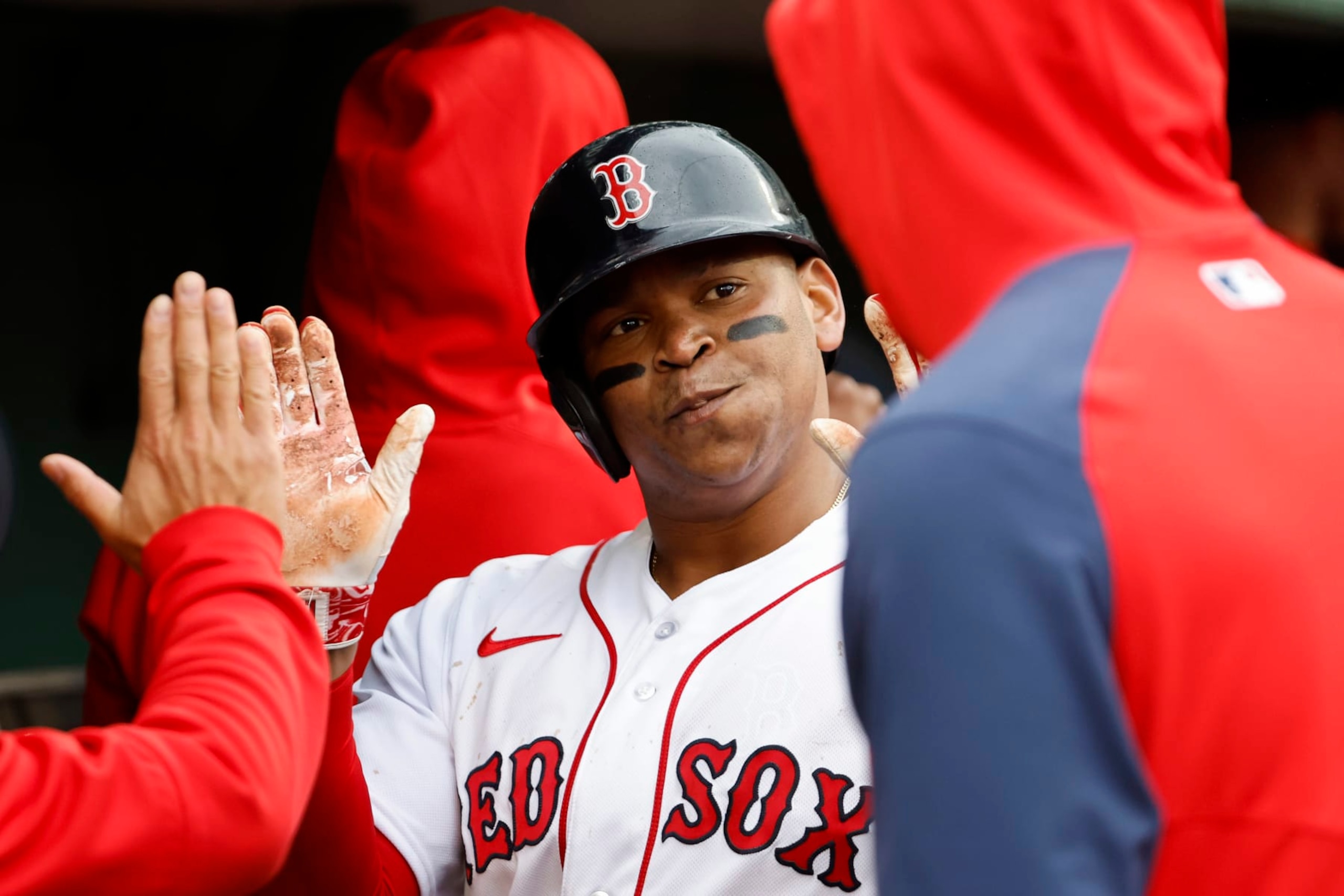 BOSTON, MA - JUNE 3: Rafael Devers #11 of the Boston Red Sox is congratulated in the dugout after scoring against the Tampa Bay Rays during the sixth inning at Fenway Park on June 3, 2023 in Boston, Massachusetts. (Photo By Winslow Townson/Getty Images)