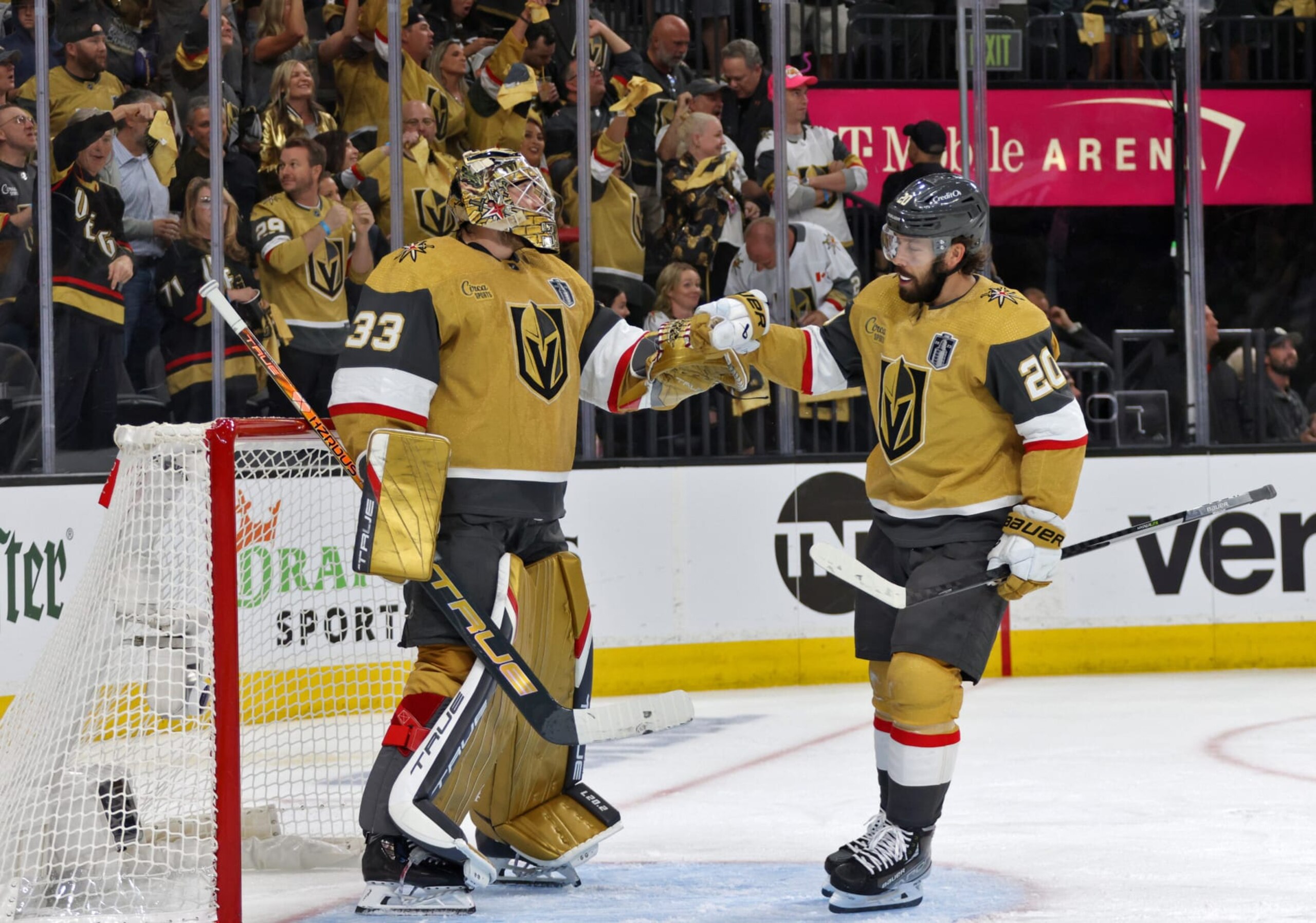 LAS VEGAS, NEVADA - JUNE 05: Chandler Stephenson #20 of the Vegas Golden Knights fist bumps teammate Adin Hill #33 during the second period of Game Two of the 2023 NHL Stanley Cup Final between the Florida Panthers and the Vegas Golden Knights at T-Mobile Arena on June 05, 2023 in Las Vegas, Nevada. (Photo by Dave Sandford/NHLI via Getty Images)