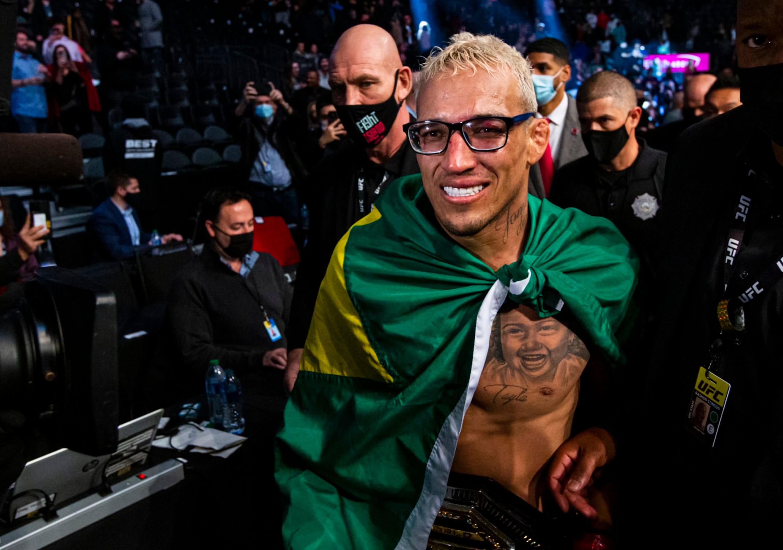 Charles Oliveira leaves the arena after defeating Dustin Poirier, not pictured, by submission in a lightweight mixed martial arts title bout at UFC 269, Saturday, Dec. 11, 2021, in Las Vegas. (AP Photo/Chase Stevens)