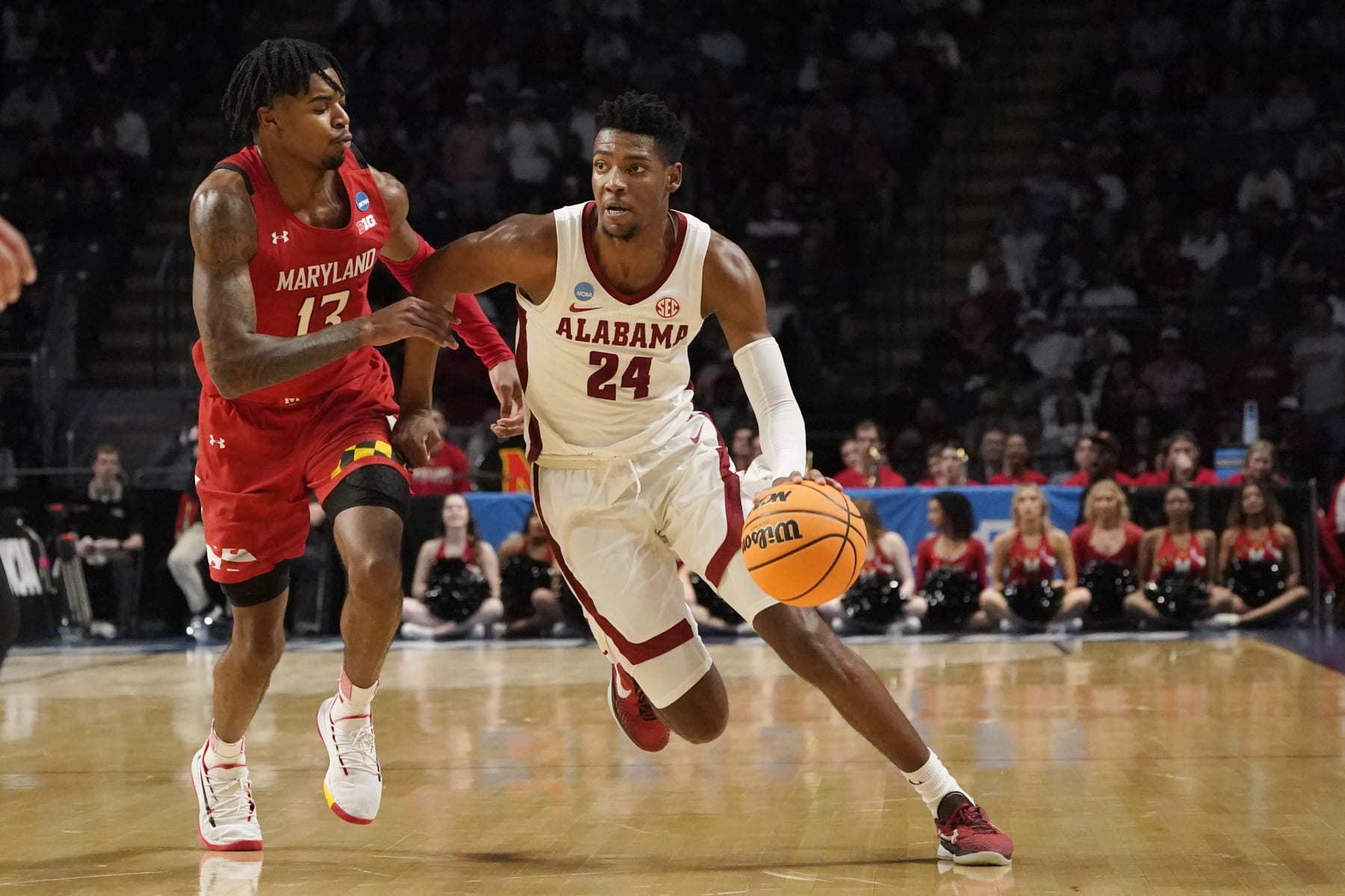 Alabama forward Brandon Miller (24) dribbles past Maryland guard Hakim Hart (13) in the second half of the second round of a college basketball game in the NCAA Tournament in Birmingham, Ala., Saturday, March 18, 2023. Alabama won 73-51. (AP Photo/Rogelio V. Solis)