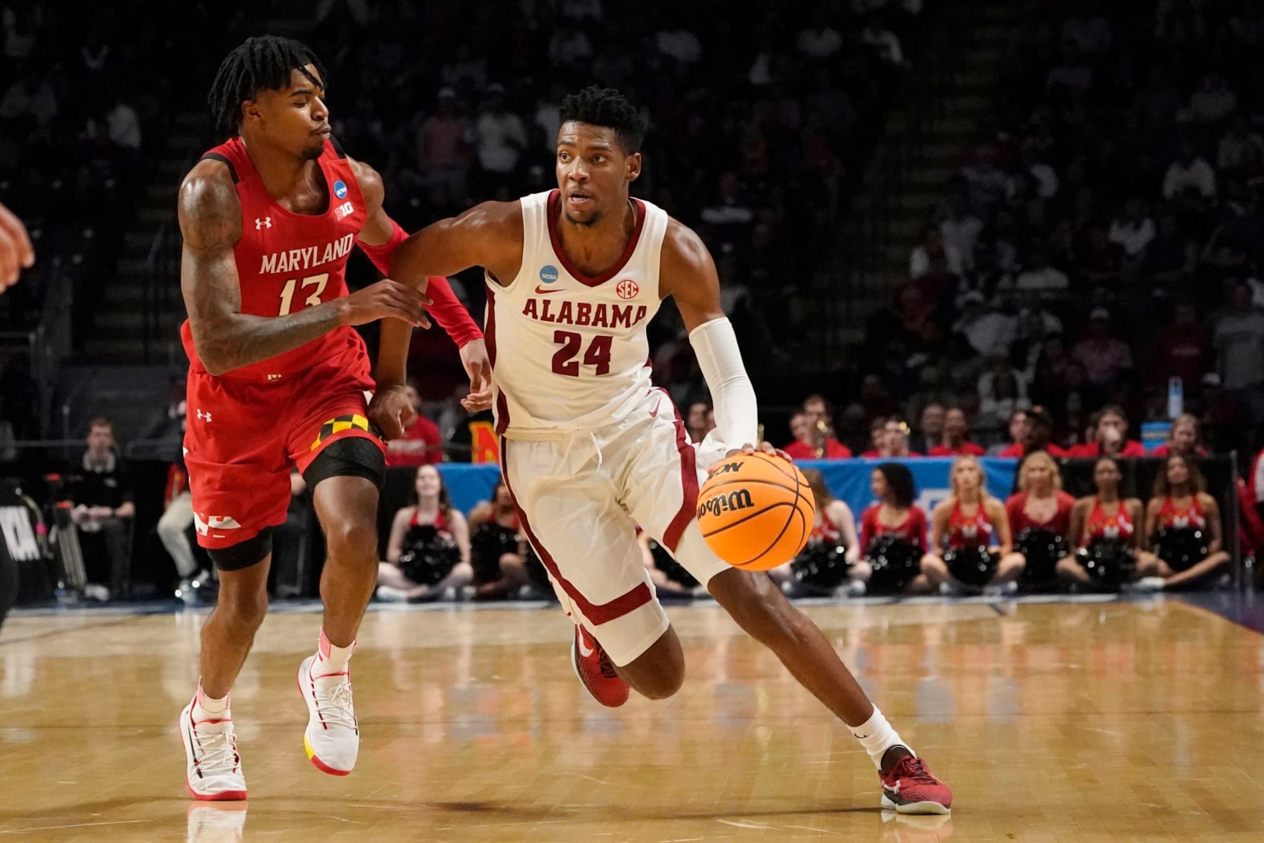 Alabama forward Brandon Miller (24) dribbles past Maryland guard Hakim Hart (13) in the second half of the second round of a college basketball game in the NCAA Tournament in Birmingham, Ala., Saturday, March 18, 2023. Alabama won 73-51. (AP Photo/Rogelio V. Solis)