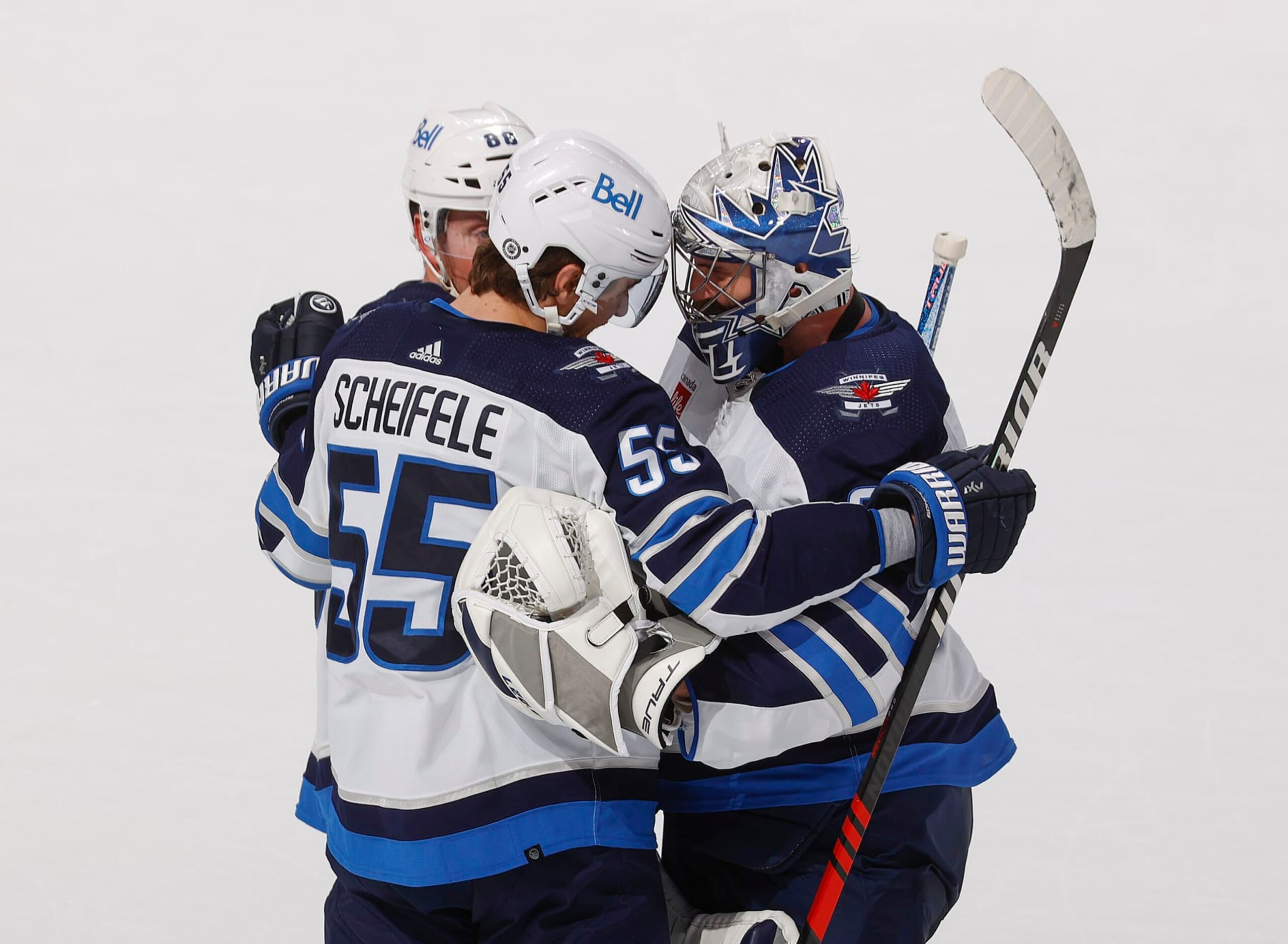 Winnipeg Jets center Mark Scheifele (left) and goaltender Connor Hellebuyck. Winnipeg Jets center Mark Scheifele (left) and goaltender Connor Hellebuyck.