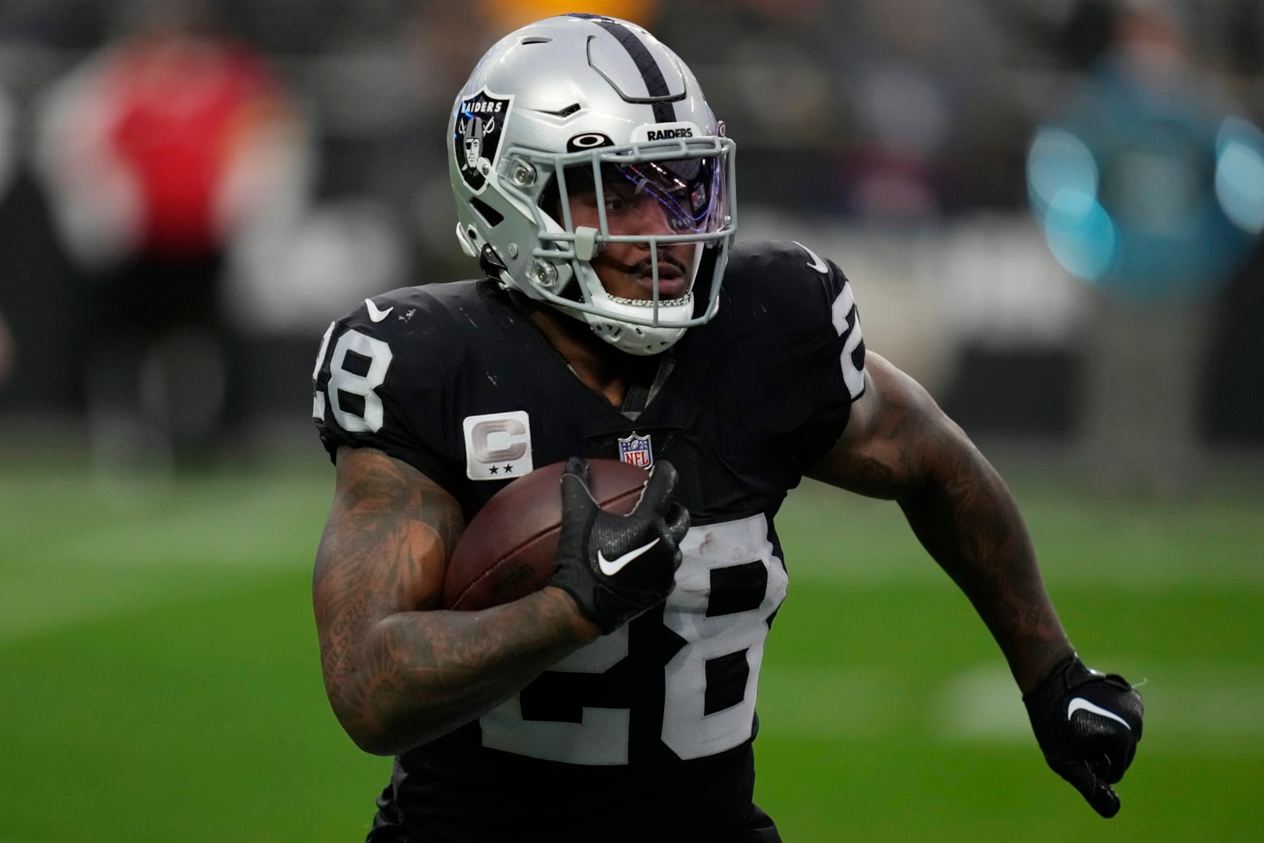 Las Vegas Raiders running back Josh Jacobs (28) runs against the Kansas City Chiefs during the first half of an NFL football game, Wednesday, Jan. 11, 2023, in Las Vegas. (AP Photo/John Locher)