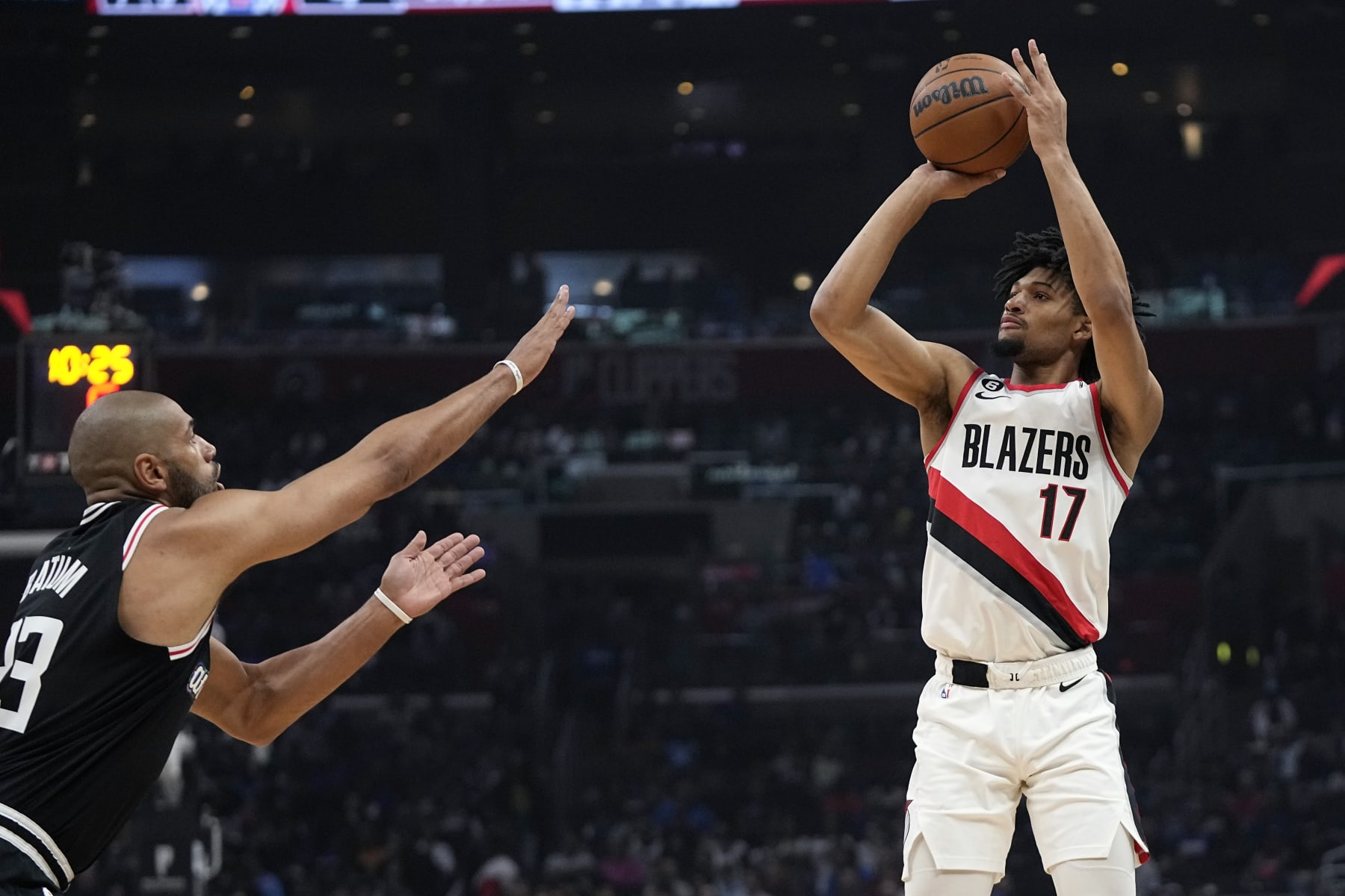 Portland Trail Blazers guard Shaedon Sharpe, right, shoots as Los Angeles Clippers forward Nicolas Batum defends during the first half of an NBA basketball game Saturday, April 8, 2023, in Los Angeles. (AP Photo/Mark J. Terrill)