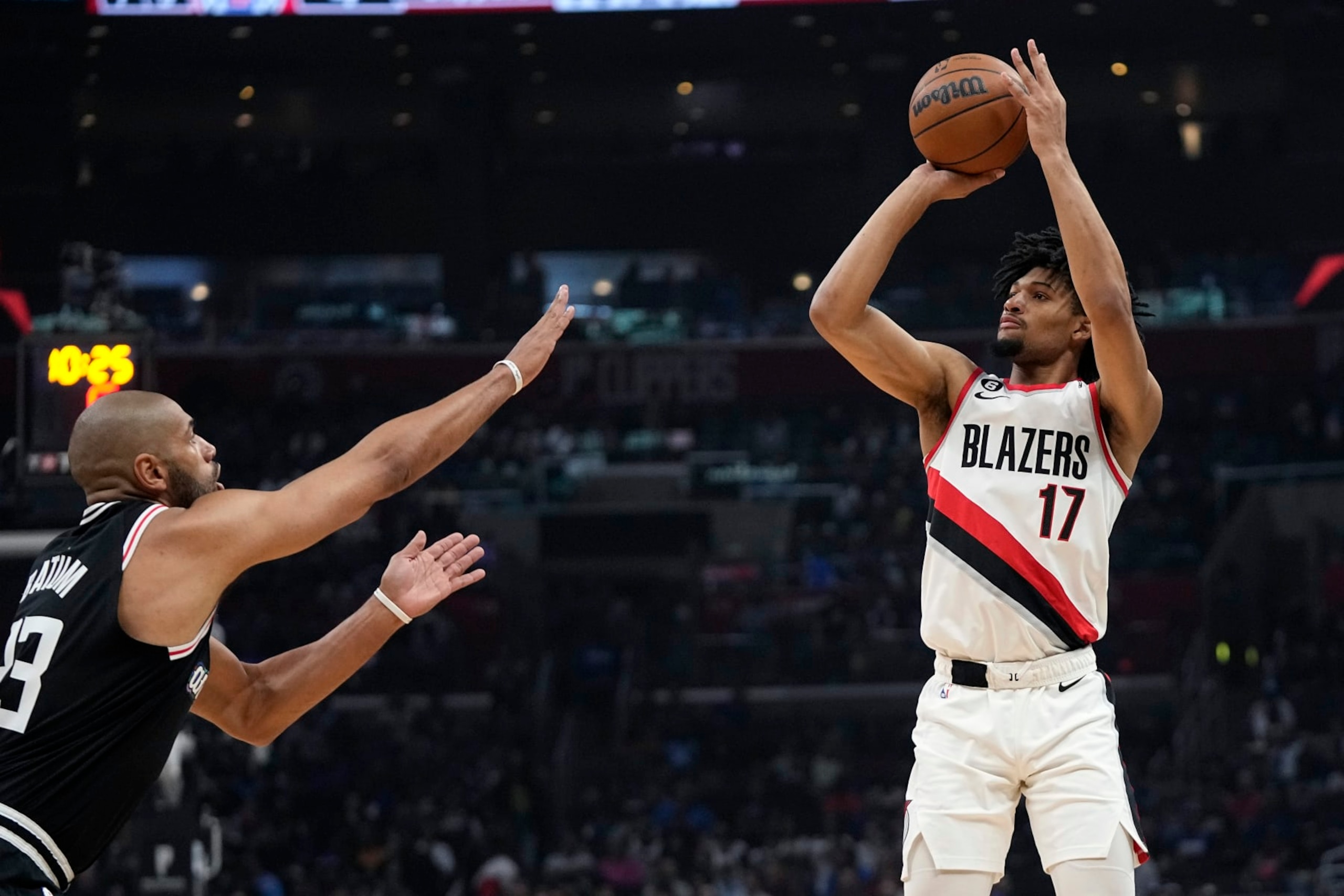 Portland Trail Blazers guard Shaedon Sharpe, right, shoots as Los Angeles Clippers forward Nicolas Batum defends during the first half of an NBA basketball game Saturday, April 8, 2023, in Los Angeles. (AP Photo/Mark J. Terrill)