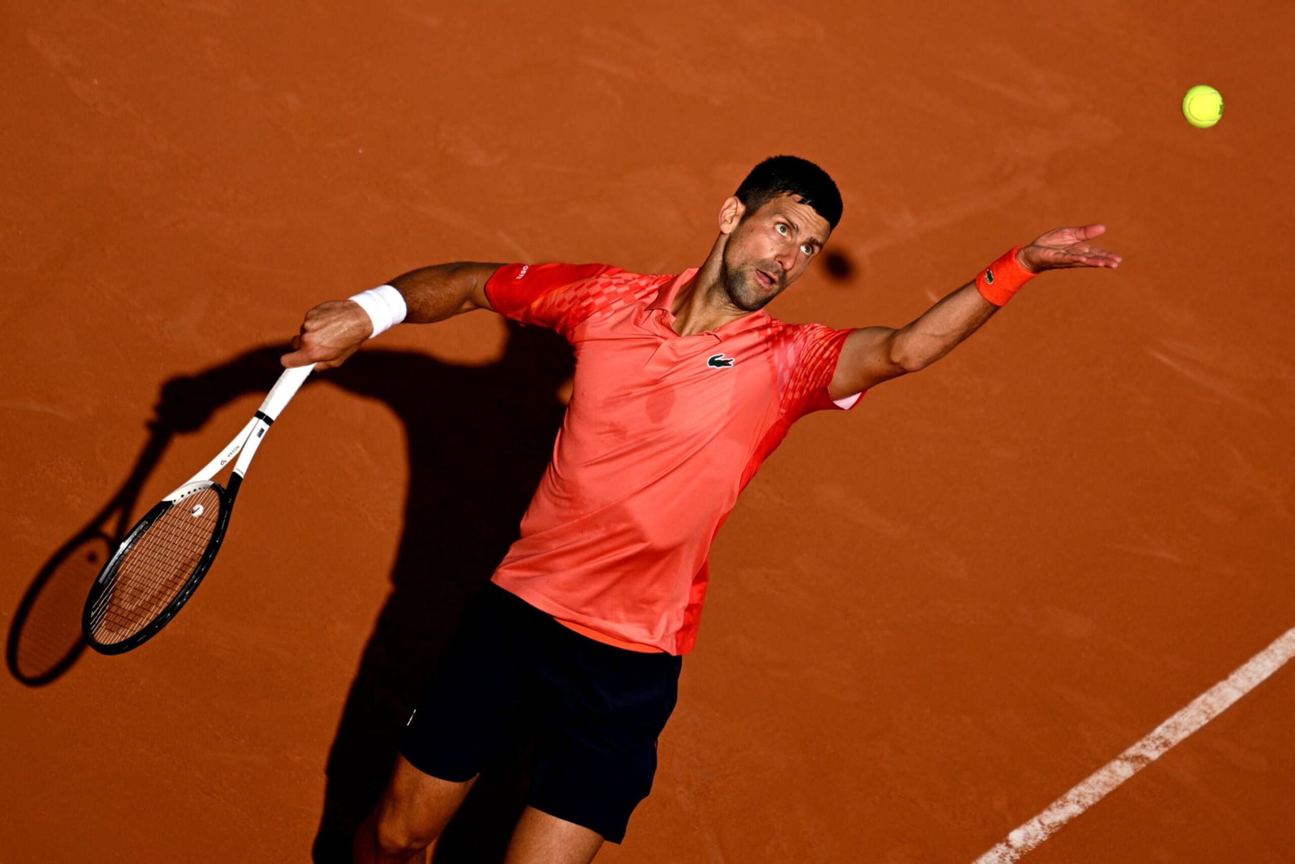 PARIS, FRANCE - JUNE 06: Novak Djokovic of Serbia serves against Karen Khachanov during the Men's Singles Quarter Final match on Day Ten of the 2023 French Open at Roland Garros on June 06, 2023 in Paris, France. (Photo by Lionel Hahn/Getty Images)