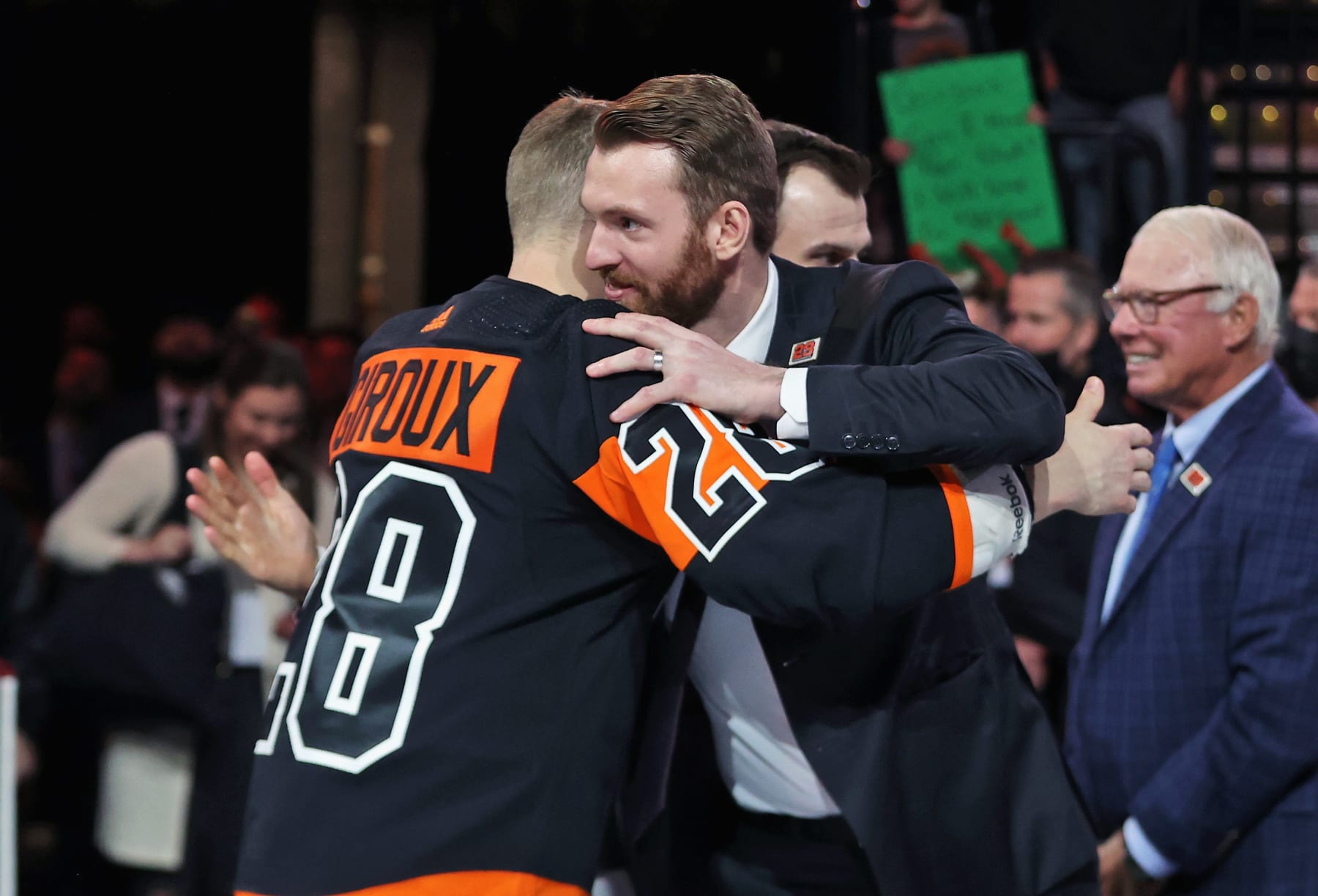 PHILADELPHIA, PA - MARCH 17:  Claude Giroux #28 of the Philadelphia Flyers hugs Sean Couturier #14 during a pregame ceremony honoring Giroux 1,000th NHL game as a member of the Flyers prior to his game against the Nashville Predators at the Wells Fargo Center on March 17, 2022 in Philadelphia, Pennsylvania.  (Photo by Len Redkoles/NHLI via Getty Images)