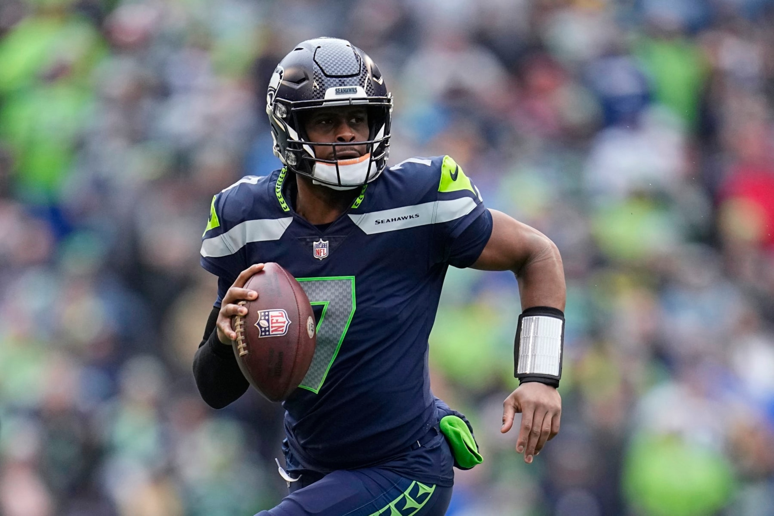 FILE - Seattle Seahawks quarterback Geno Smith (7) runs with the ball during the first half of the team's NFL football game against the Los Angeles Rams, Jan. 8, 2023, in Seattle. New York Giants running back Saquon Barkley, 49ers running back Christian McCaffrey and Smith are the finalists for AP Comeback Player of the Year. (AP Photo/Abbie Parr, File)