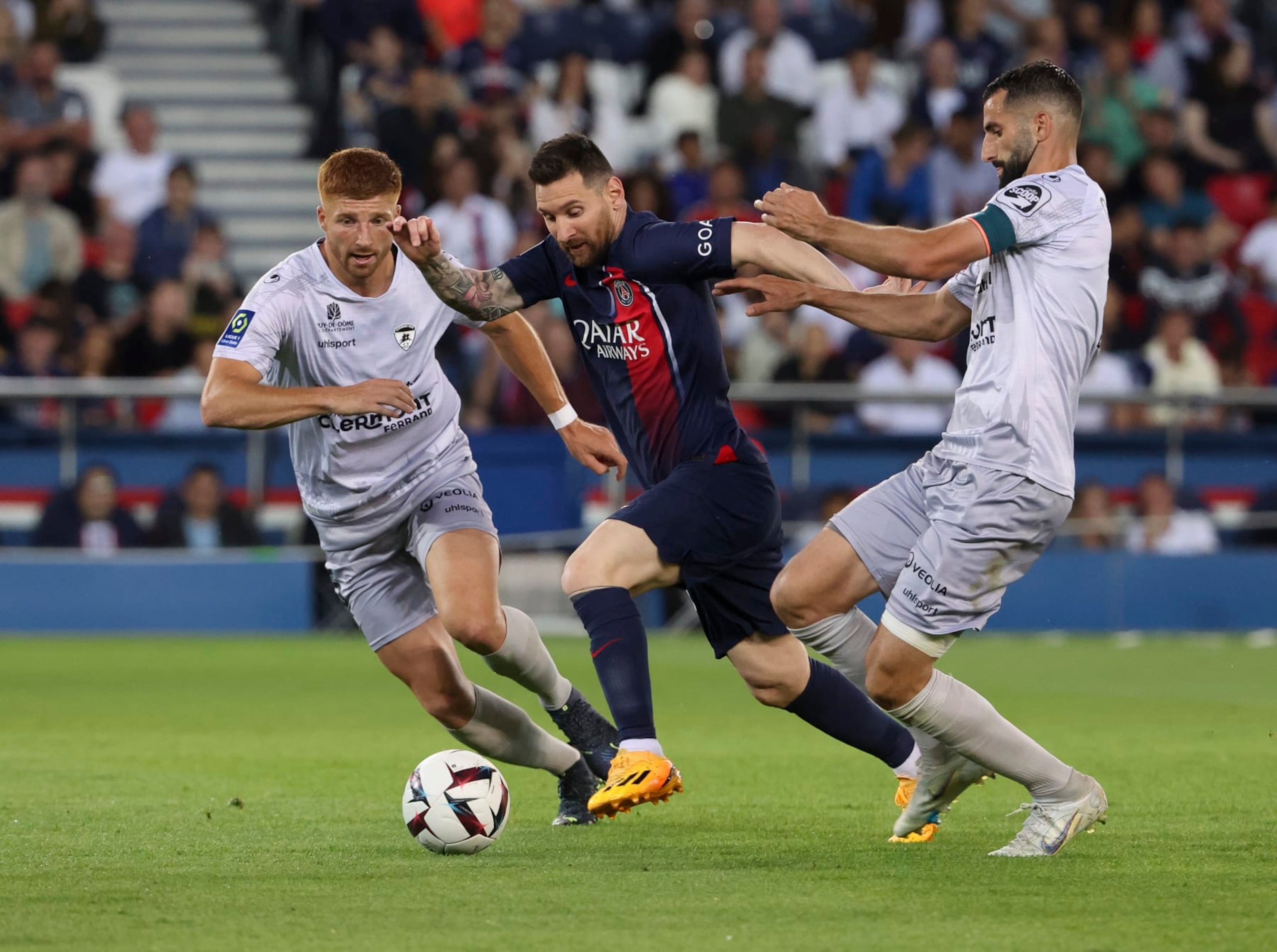 PARIS, FRANCE - JUNE 3: Lionel Messi of PSG in action between Maximiliano Caufriez and Maxime Gonalons of Clermont during the Ligue 1 match between Paris Saint-Germain (PSG) and Clermont Foot 63 at Parc des Princes stadium on June 3, 2023 in Paris, France. (Photo by Jean Catuffe/Getty Images)