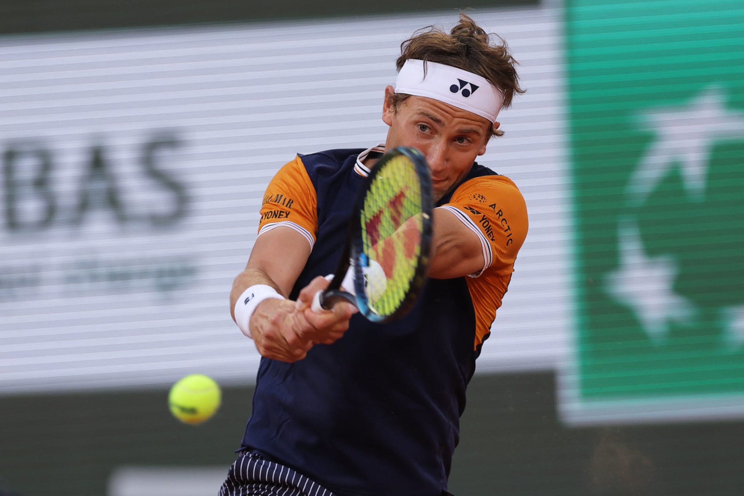 Norway's Casper Ruud plays a backhand return to Denmark's Holger Rune during their men's singles quarter final match on day eleven of the Roland-Garros Open tennis tournament at the Court Philippe-Chatrier in Paris on June 7, 2023. (Photo by Thomas SAMSON / AFP) (Photo by THOMAS SAMSON/AFP via Getty Images)