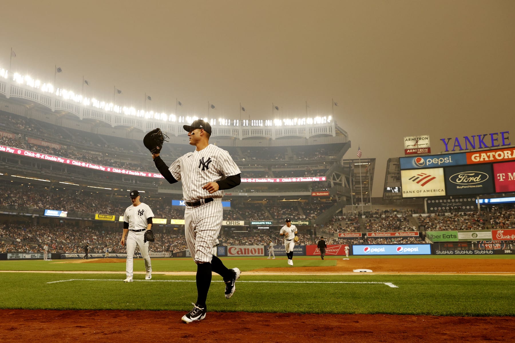 NEW YORK, NEW YORK - JUNE 06: General view of hazy conditions resulting from Canadian wildfires as Anthony Rizzo #48 of the New York Yankees jogs to the dugout during the second inning against the Chicago White Sox at Yankee Stadium on June 06, 2023 in the Bronx borough of New York City. (Photo by Sarah Stier/Getty Images)
