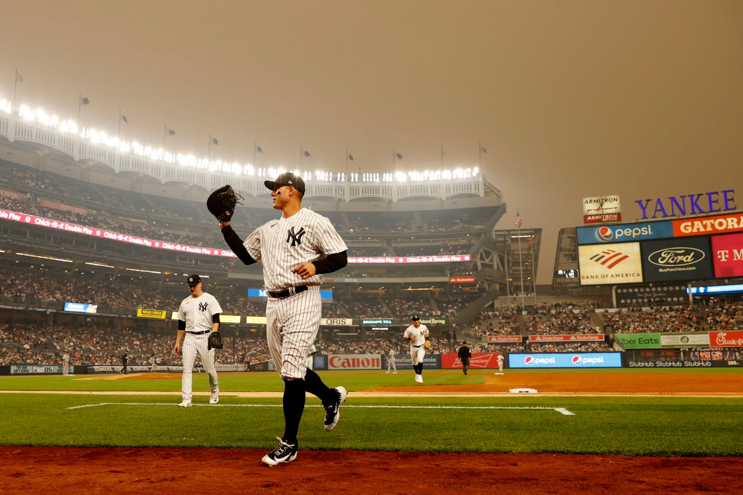 NEW YORK, NEW YORK - JUNE 06: General view of hazy conditions resulting from Canadian wildfires as Anthony Rizzo #48 of the New York Yankees jogs to the dugout during the second inning against the Chicago White Sox at Yankee Stadium on June 06, 2023 in the Bronx borough of New York City. (Photo by Sarah Stier/Getty Images)