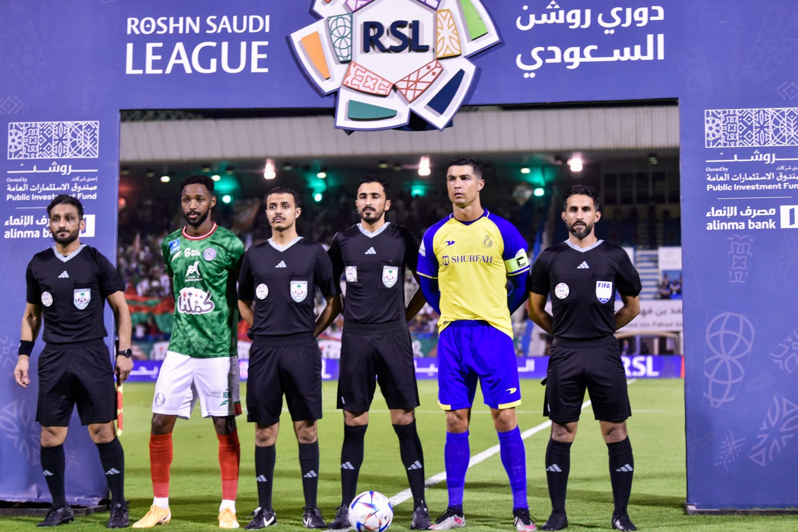Nassr's Portuguese forward and team captain Cristiano Ronaldo (2nd R) and Ettifaq's Saudi midfielder and team captain Ali Hazazi (2nd L) pose for a picture with the referee team ahead of the Saudi Pro League football match between Al-Nassr and Al-Ettifaq at the Prince Mohammed Bin Fahd Stadium in Dammam on May 27, 2023. (Photo by AFP) (Photo by -/AFP via Getty Images)
