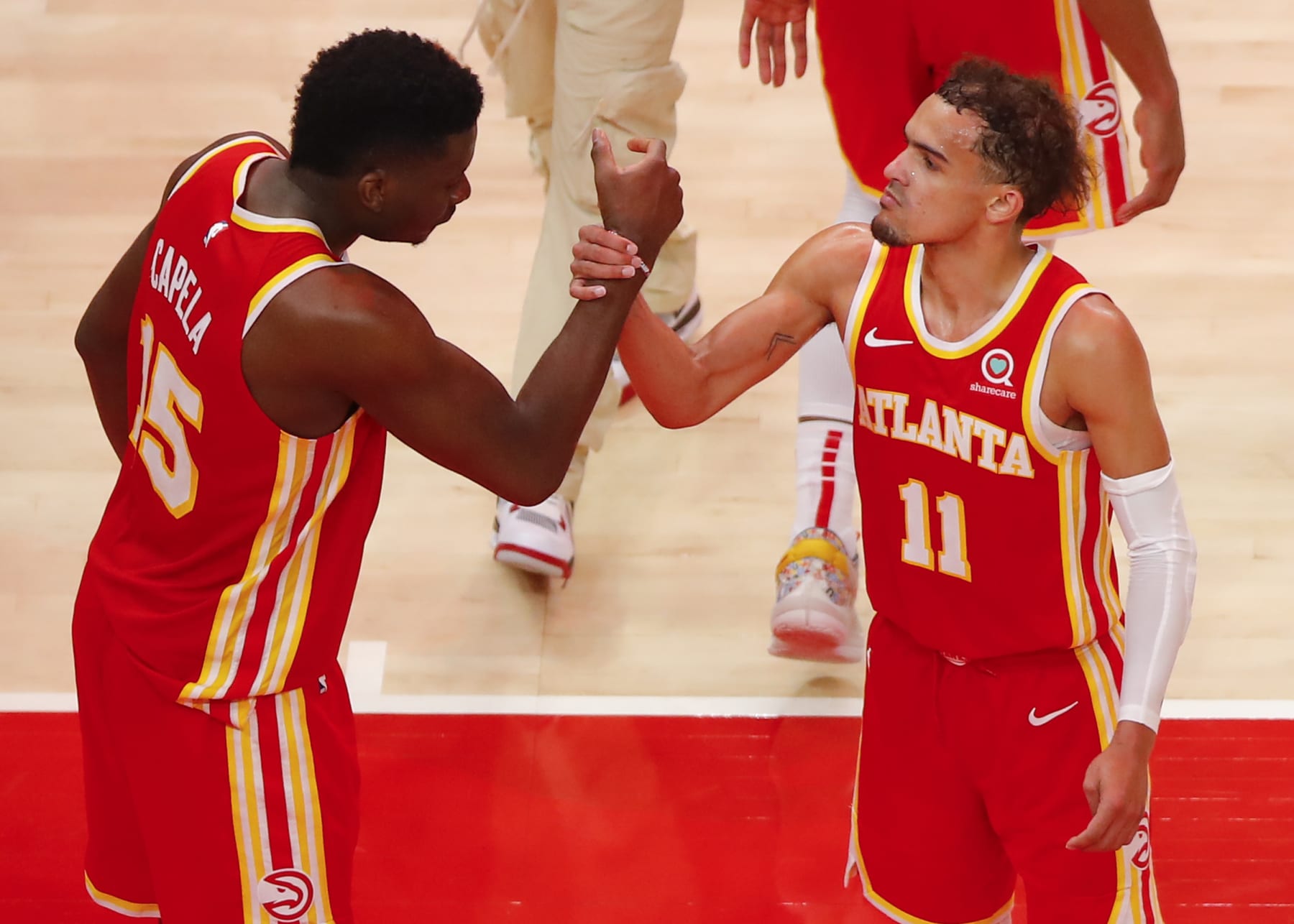ATLANTA, GA - MAY 28: Trae Young #11 reacts with Clint Capela #15 of the Atlanta Hawks at the conclusion of the game against the New York Knicks in game three of the Eastern Conference Quarterfinals at State Farm Arena on May 28, 2021 in Atlanta, Georgia. NOTE TO USER: User expressly acknowledges and agrees that, by downloading and/or using this photograph, user is consenting to the terms and conditions of the Getty Images License Agreement. (Photo by Todd Kirkland/Getty Images)