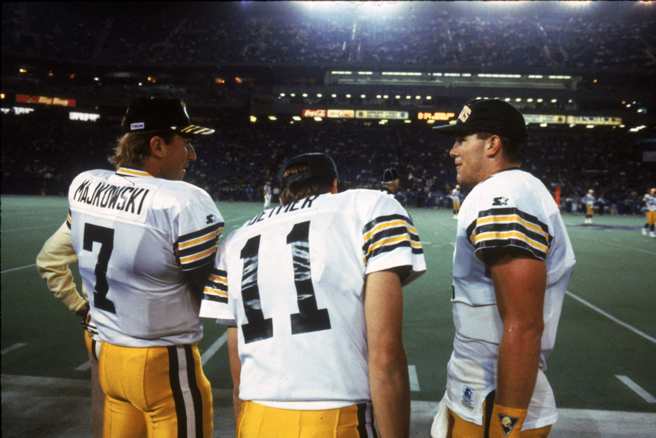 HOUSTON - DECEMBER 13:  Quarterbacks Don Majkowski #7, Ty Detmer #11 and Brett Favre #4 of the Green Bay Packers talk on the sidelines during a 16-14 win over the Houston Oilers at the Astrodome in Houston, Texas on December 13, 1992. (Photo by James Biever/Getty Images)