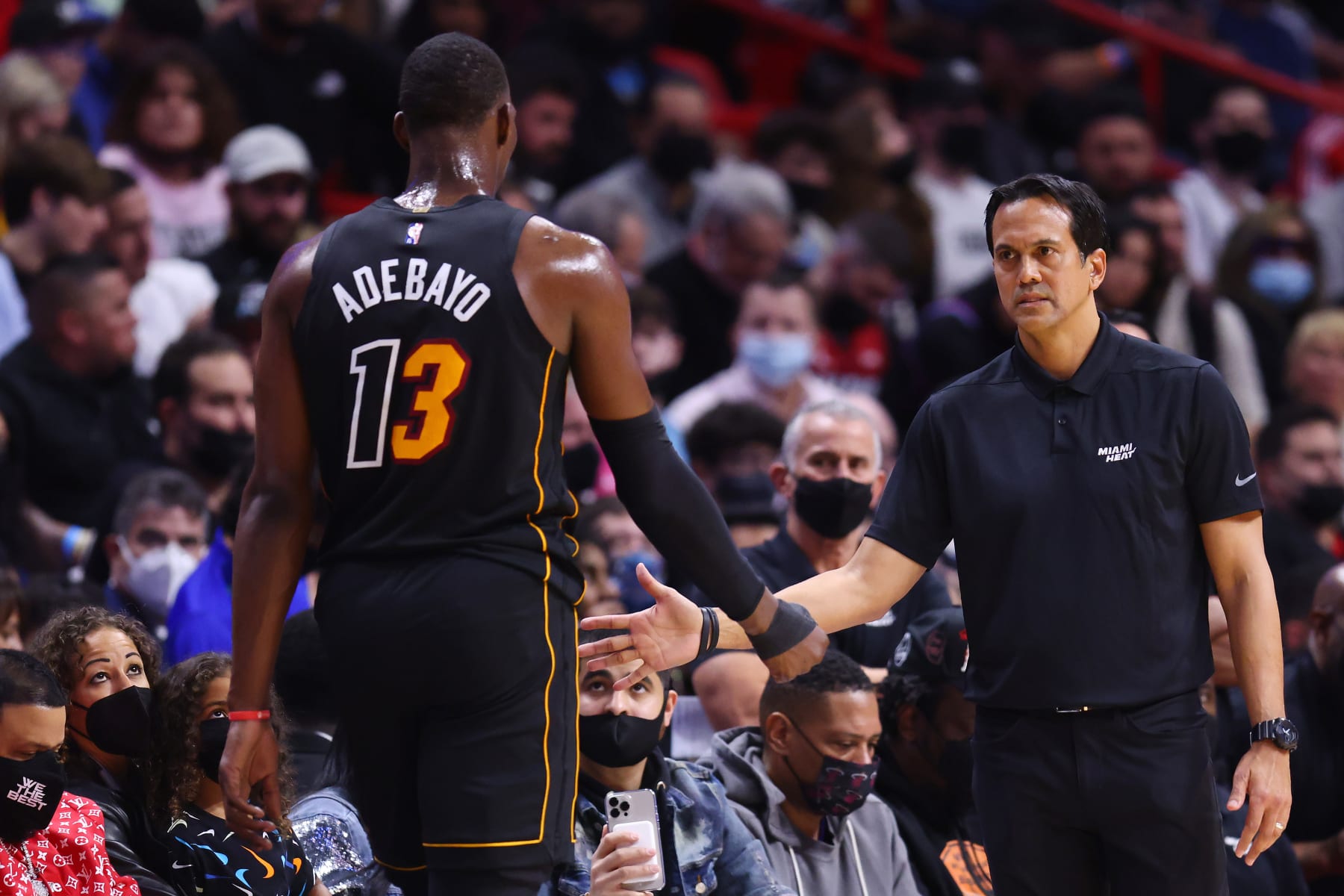 MIAMI, FLORIDA - JANUARY 23: Bam Adebayo #13 of the Miami Heat high fives head coach Erik Spoelstra against the Los Angeles Lakers at FTX Arena on January 23, 2022 in Miami, Florida. NOTE TO USER: User expressly acknowledges and agrees that, by downloading and or using this photograph, User is consenting to the terms and conditions of the Getty Images License Agreement.  (Photo by Michael Reaves/Getty Images)