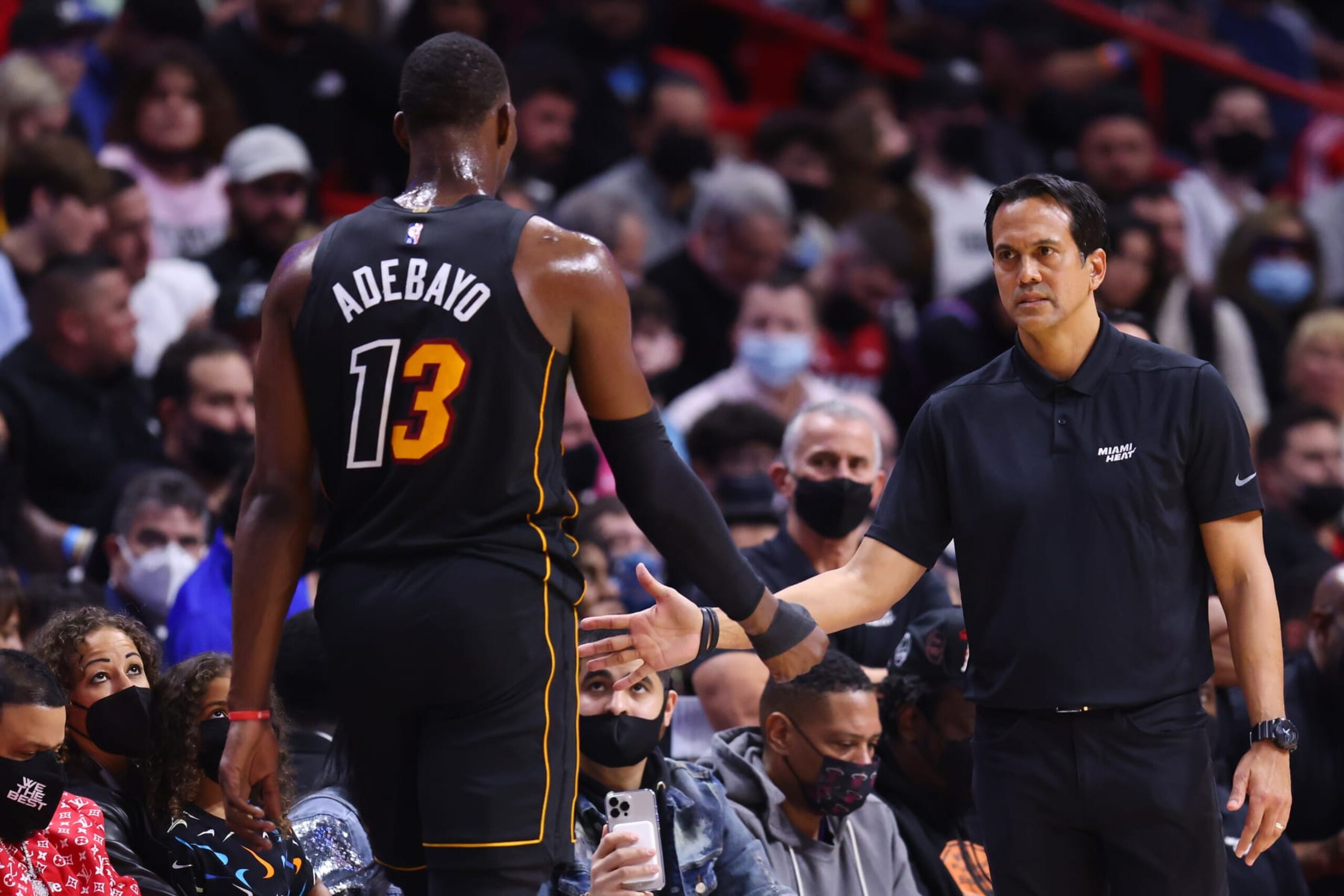 MIAMI, FLORIDA - JANUARY 23: Bam Adebayo #13 of the Miami Heat high fives head coach Erik Spoelstra against the Los Angeles Lakers at FTX Arena on January 23, 2022 in Miami, Florida. NOTE TO USER: User expressly acknowledges and agrees that, by downloading and or using this photograph, User is consenting to the terms and conditions of the Getty Images License Agreement.  (Photo by Michael Reaves/Getty Images)