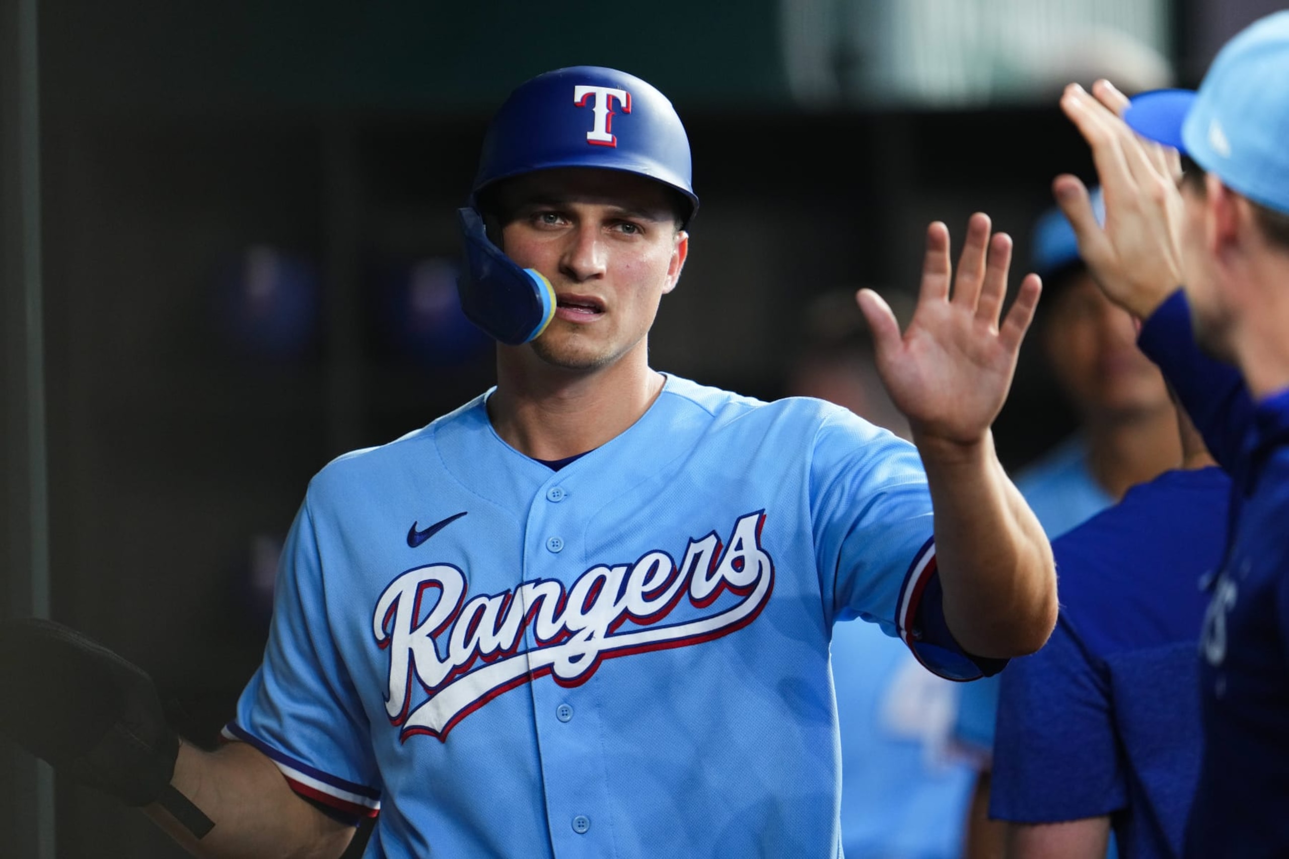 ARLINGTON, TX - JUNE 04:   Corey Seager #5 of the Texas Rangers high-fives teammates in the dugout after scoring off a single from Josh Jung #6 in the sixth inning during the game between the Seattle Mariners and the Texas Rangers at Globe Life Field on Sunday, June 4, 2023 in Arlington, Texas. (Photo by Cooper Neill/MLB Photos via Getty Images)