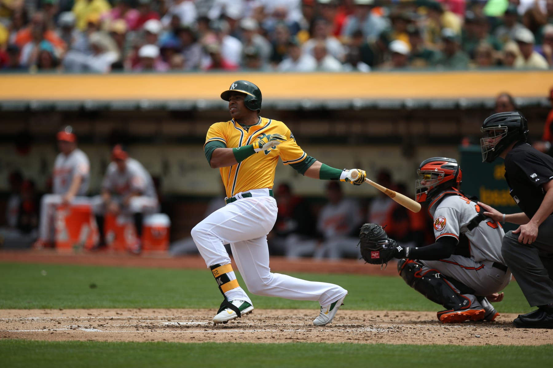 OAKLAND, CA - JULY 20:  Yoenis Cespedes #52 of the Oakland Athletics bats against the Baltimore Orioles during the game at O.co Coliseum on Sunday, July 20, 2014 in Oakland, California. (Photo by Brad Mangin/MLB Photos via Getty Images) 