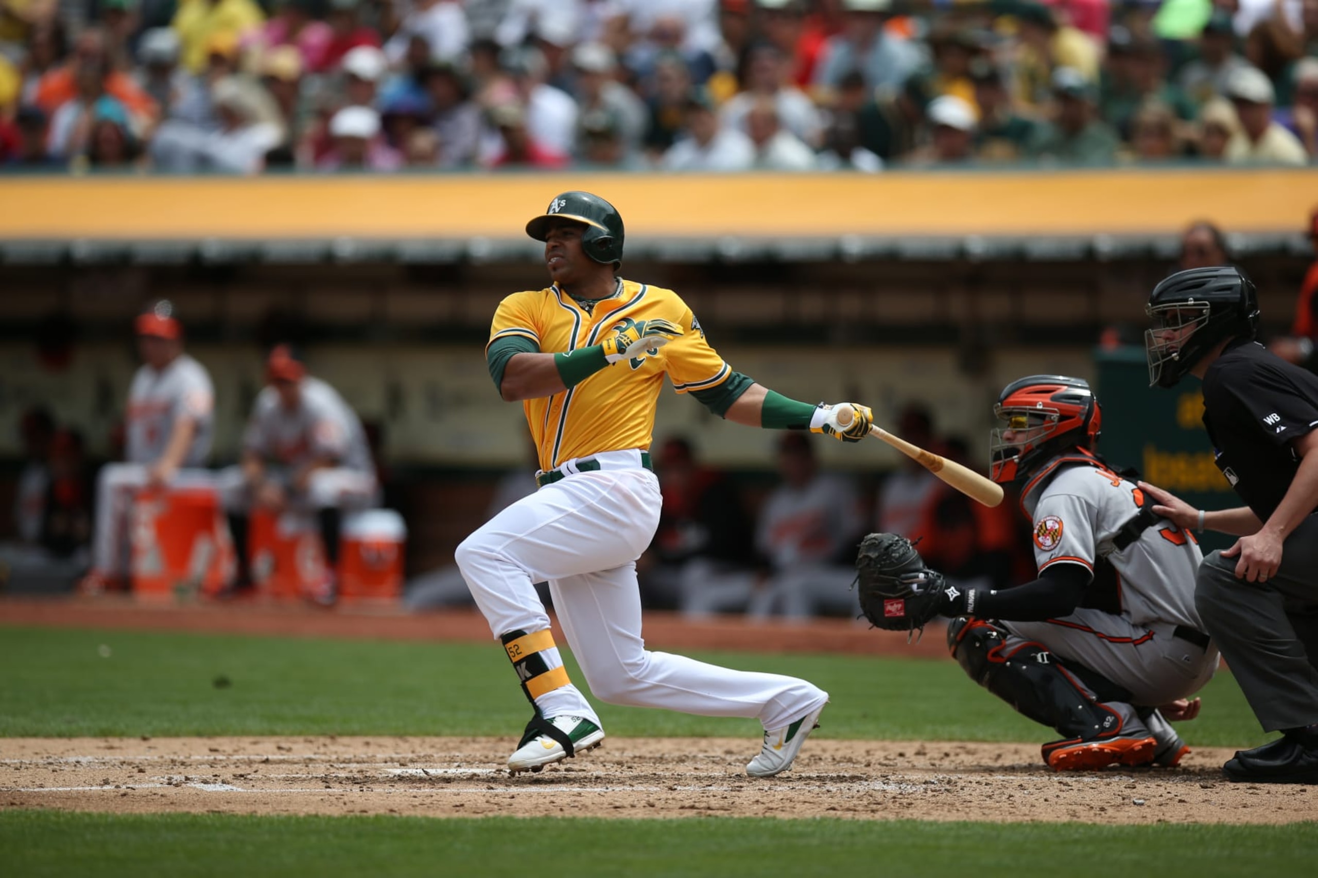 OAKLAND, CA - JULY 20:  Yoenis Cespedes #52 of the Oakland Athletics bats against the Baltimore Orioles during the game at O.co Coliseum on Sunday, July 20, 2014 in Oakland, California. (Photo by Brad Mangin/MLB Photos via Getty Images) 