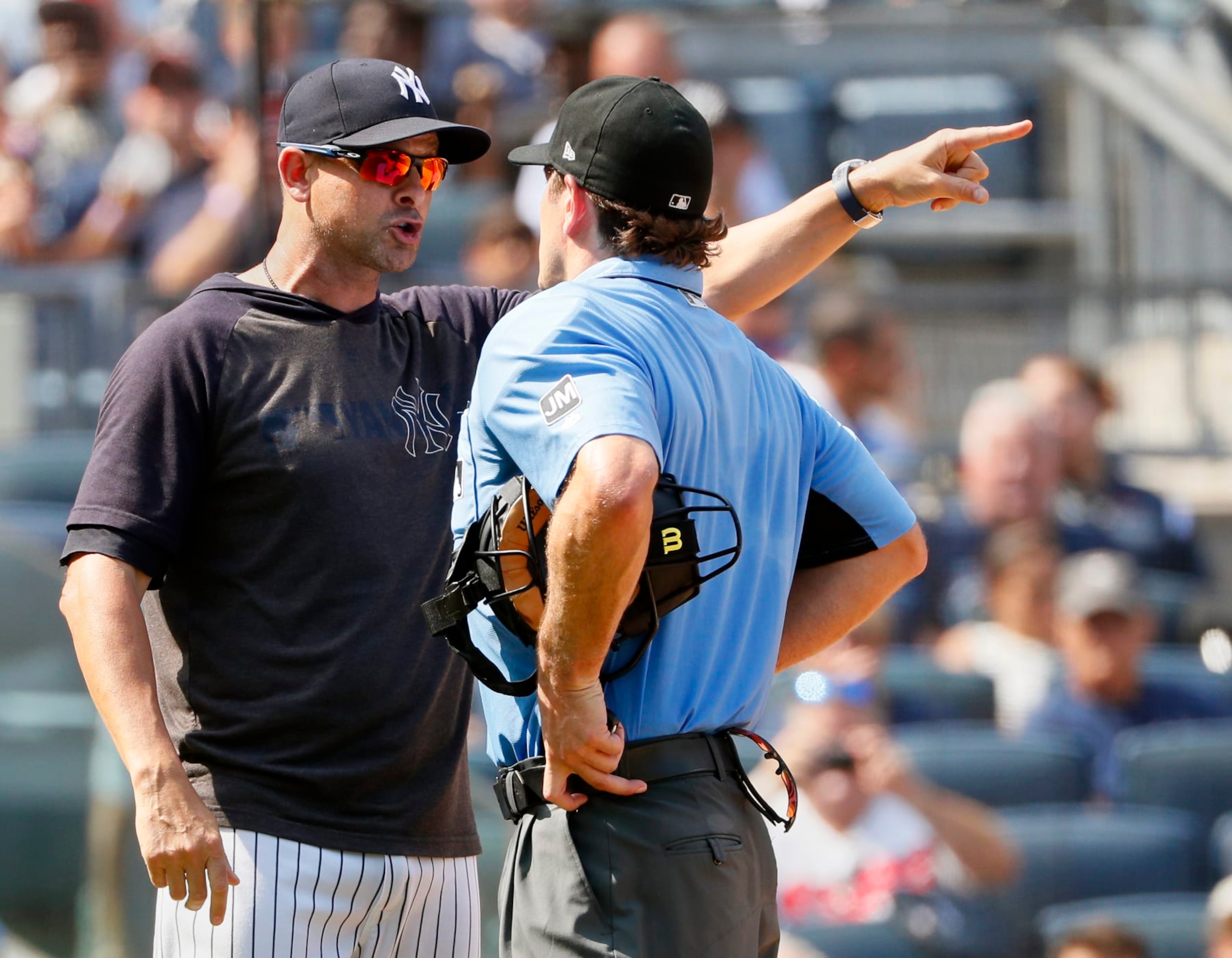 NEW YORK, NY - AUGUST 17:  Umpire Ben May #97 listens to manager Aaron Boone #17 of the New York Yankees who charged out of the dugout yelling at May after Boone was ejected from the game for complaining about Cameron Maybin #38 of the Yankees being called out on strikes in the 6th inning in an MLB baseball game against the Cleveland Indians at Yankee Stadium in the Bronx borough of New York City on August 17, 2019. Yankees won 6-5. (Photo by Paul Bereswill/Getty Images)