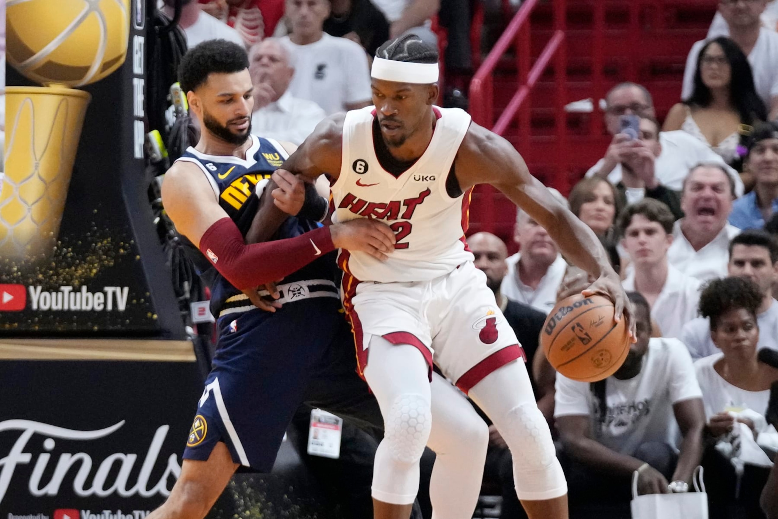 Denver Nuggets guard Jamal Murray (27) defends Miami Heat forward Jimmy Butler (22) during the first half of Game 4 of the basketball NBA Finals, Friday, June 9, 2023, in Miami. (AP Photo/Wilfredo Lee)