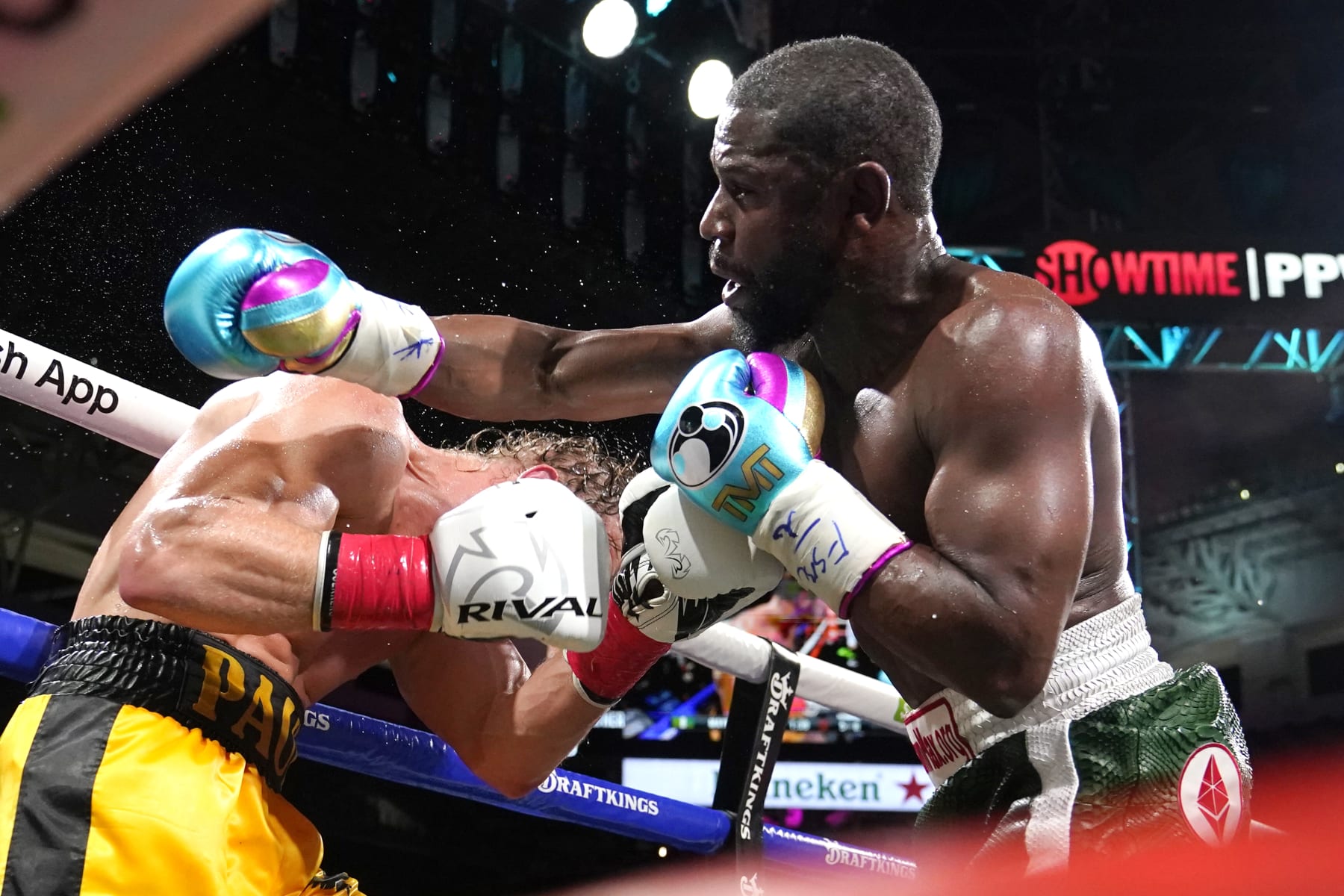 Floyd Mayweather, right, and Logan Paul fight during an exhibition boxing match at Hard Rock Stadium, Sunday, June 6, 2021, in Miami Gardens, Fla. (AP Photo/Lynne Sladky)