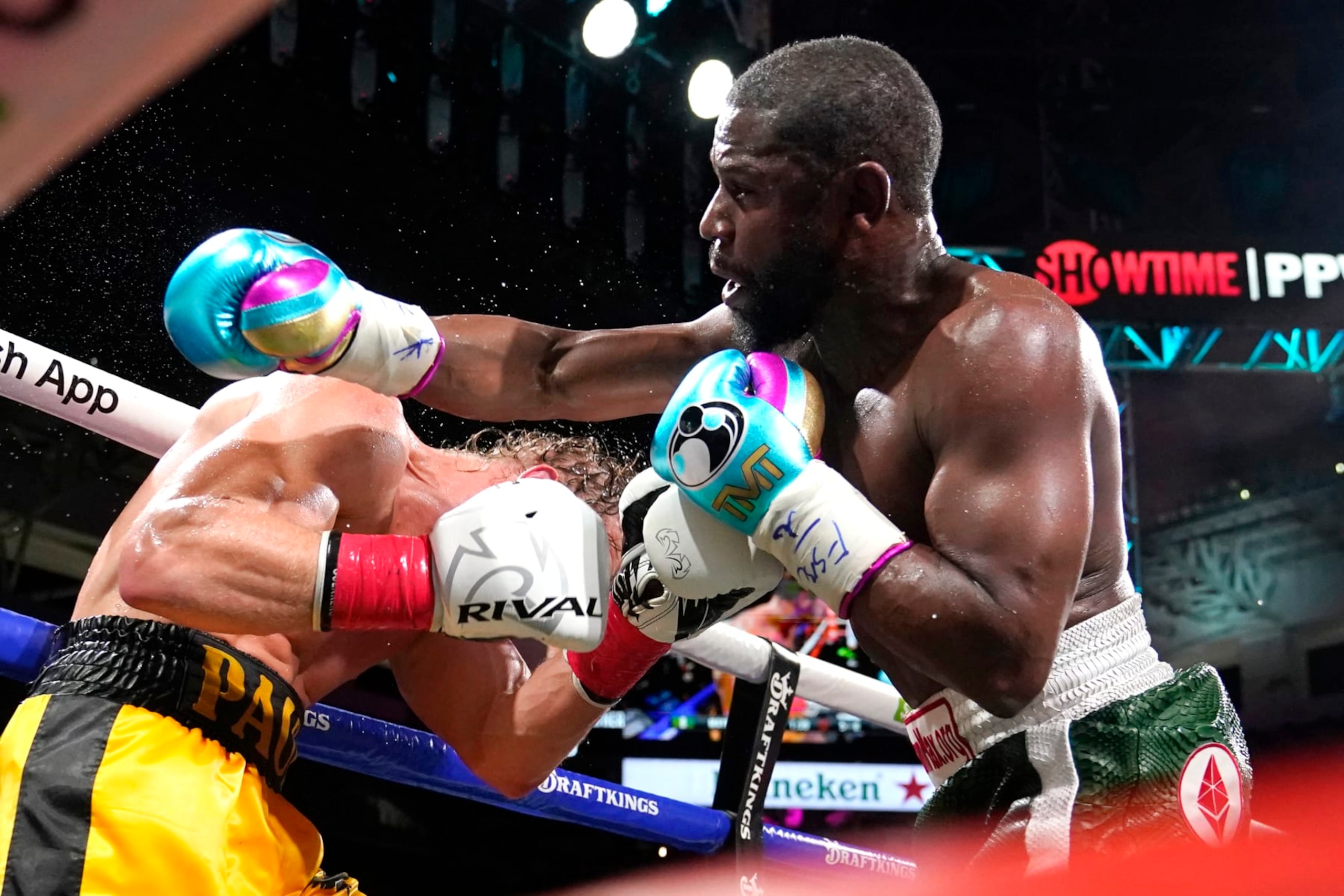 Floyd Mayweather, right, and Logan Paul fight during an exhibition boxing match at Hard Rock Stadium, Sunday, June 6, 2021, in Miami Gardens, Fla. (AP Photo/Lynne Sladky)