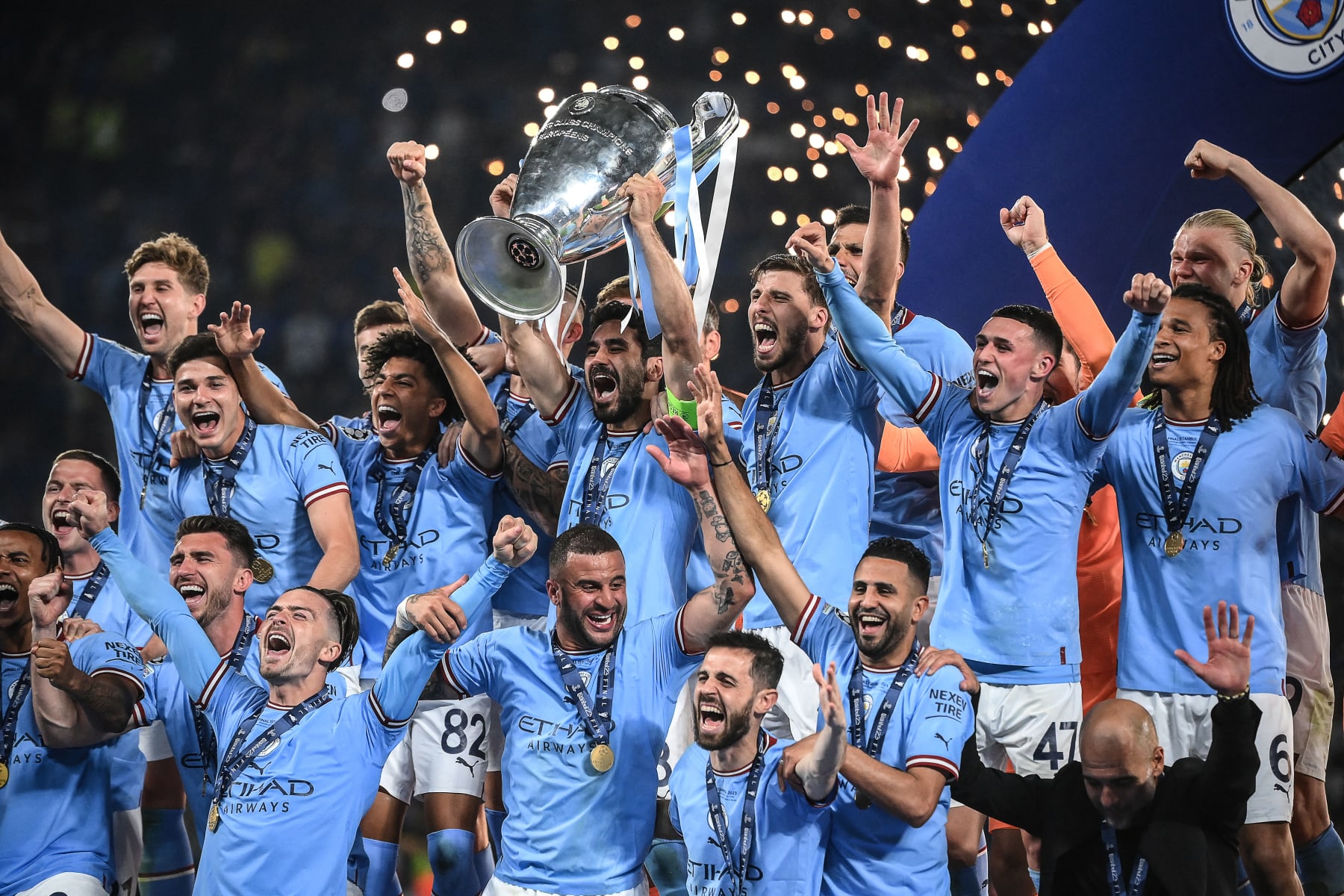 Manchester City's German midfielder #8 Ilkay Gundogan (C) lifts the European Cup trophy as they celebrate on the podium after winning the UEFA Champions League final football match between Inter Milan and Manchester City at the Ataturk Olympic Stadium in Istanbul, on June 10, 2023. (Photo by FRANCK FIFE / AFP) (Photo by FRANCK FIFE/AFP via Getty Images)