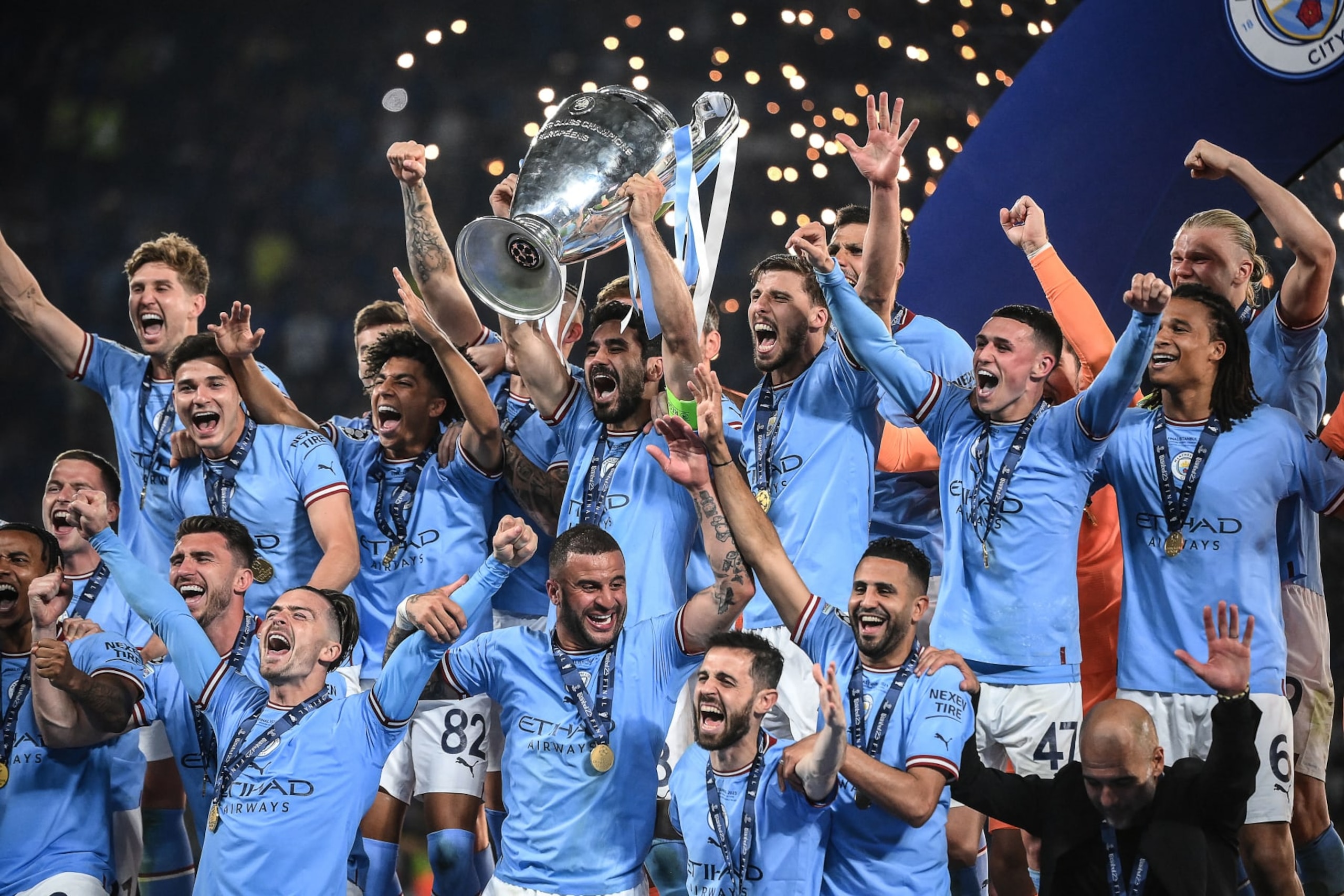 Manchester City's German midfielder #8 Ilkay Gundogan (C) lifts the European Cup trophy as they celebrate on the podium after winning the UEFA Champions League final football match between Inter Milan and Manchester City at the Ataturk Olympic Stadium in Istanbul, on June 10, 2023. (Photo by FRANCK FIFE / AFP) (Photo by FRANCK FIFE/AFP via Getty Images) Manchester City's German midfielder #8 Ilkay Gundogan (C) lifts the European Cup trophy as they celebrate on the podium after winning the UEFA Champions League final football match between Inter Milan and Manchester City at the Ataturk Olympic Stadium in Istanbul, on June 10, 2023. (Photo by FRANCK FIFE / AFP) (Photo by FRANCK FIFE/AFP via Getty Images)