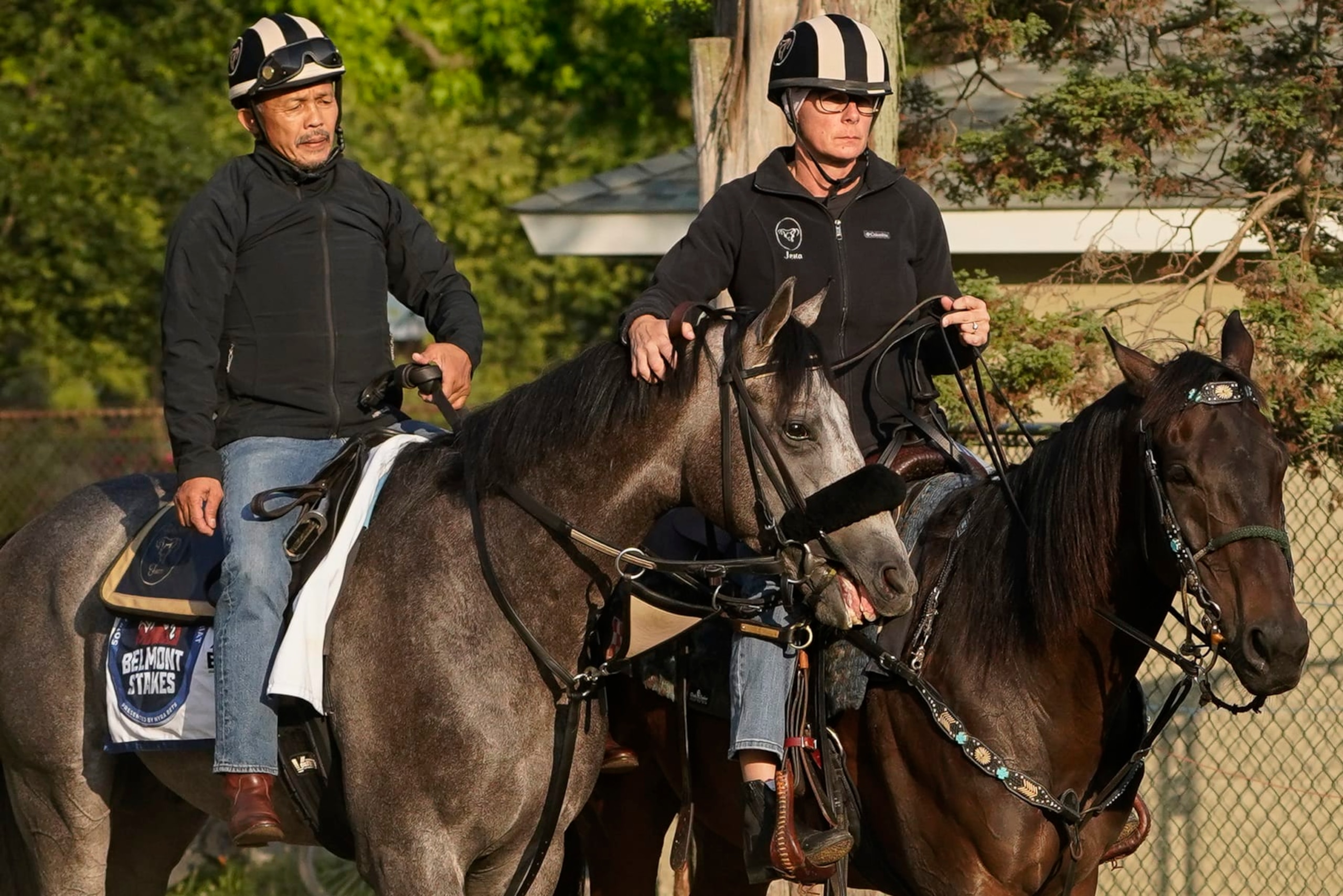 Arcangelo, left, is walked back to the stables with trainer Jena Antonucci, right, ahead of the Belmont Stakes horse race, Friday, June 9, 2023, at Belmont Park in Elmont, N.Y. (AP Photo/John Minchillo)