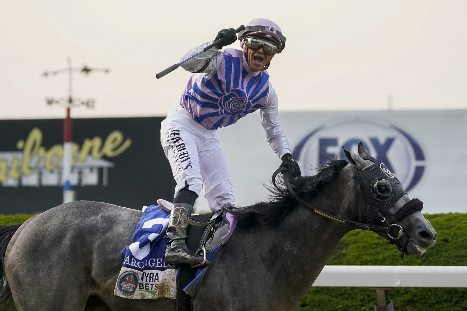 Jockey Javier Castellano, atop Arcangelo, celebrates after crossing the finish line to win the 155th running of the Belmont Stakes horse race, Saturday, June 10, 2023, at Belmont Park in Elmont, N.Y. (AP Photo/John Minchillo)