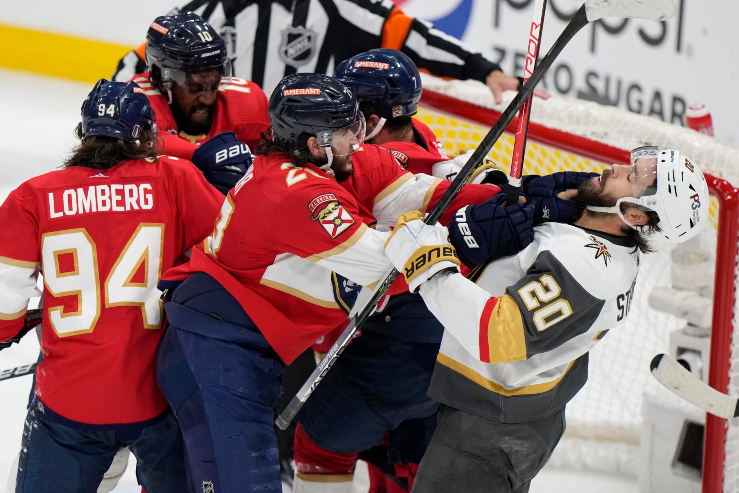 Florida Panthers defenseman Josh Mahura (28) and Vegas Golden Knights center Chandler Stephenson (20) fight during the third period in Game 4 of the NHL hockey Stanley Cup Finals, Saturday, June 10, 2023, in Sunrise, Fla. (AP Photo/Wilfredo Lee)